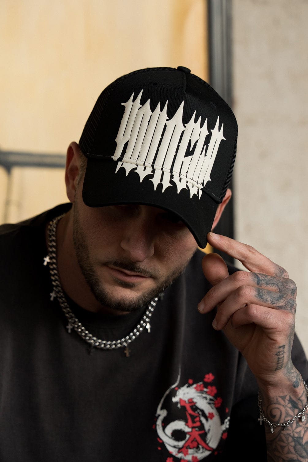 Side view of logo hats styled with denim jacket in urban setting