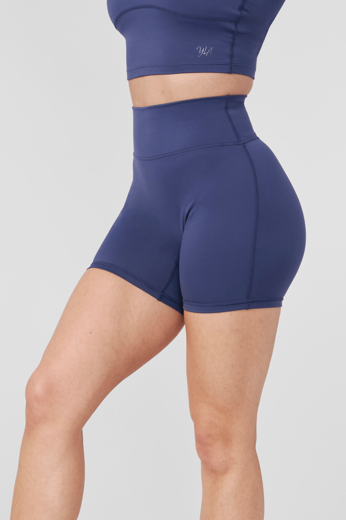 Back angle showing reflective logo and smooth waistline on biker shorts women style.
