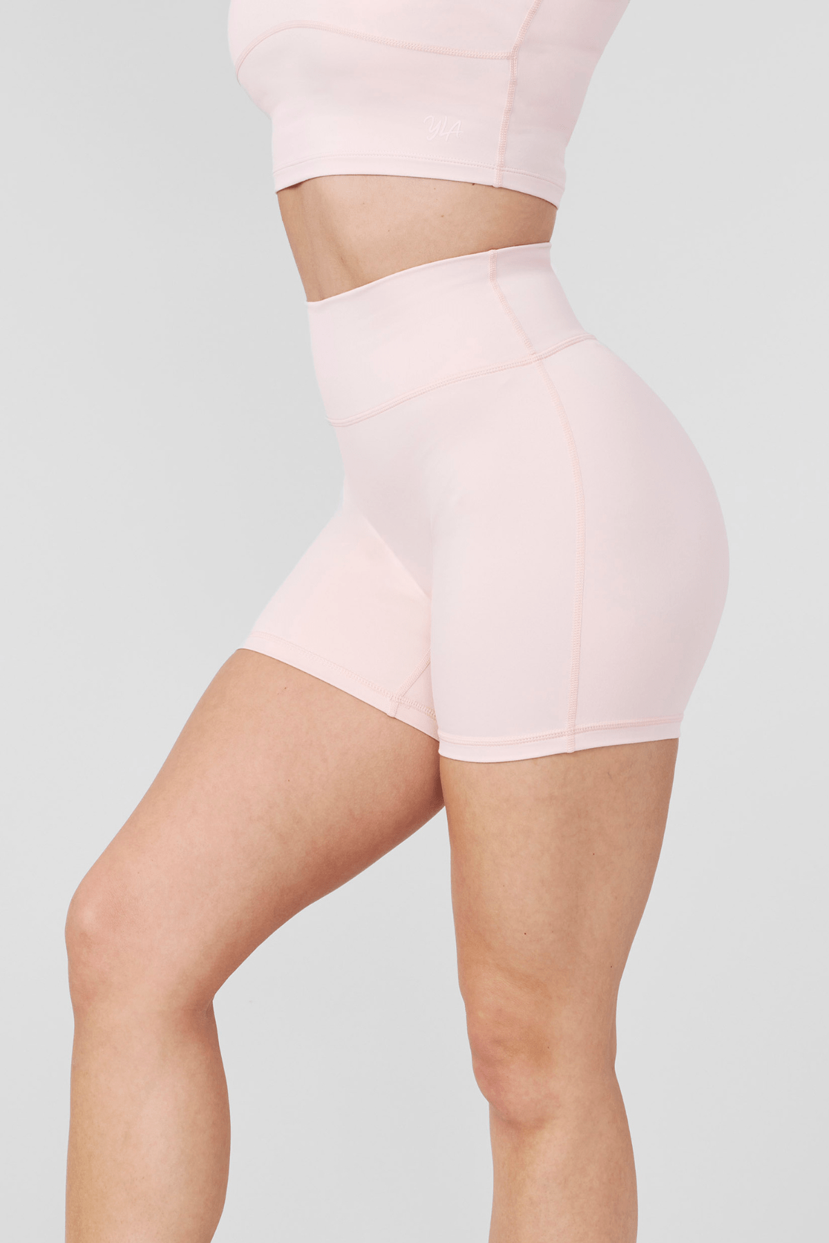 Front fit view highlighting no front seam on womens bike shorts in matte black.