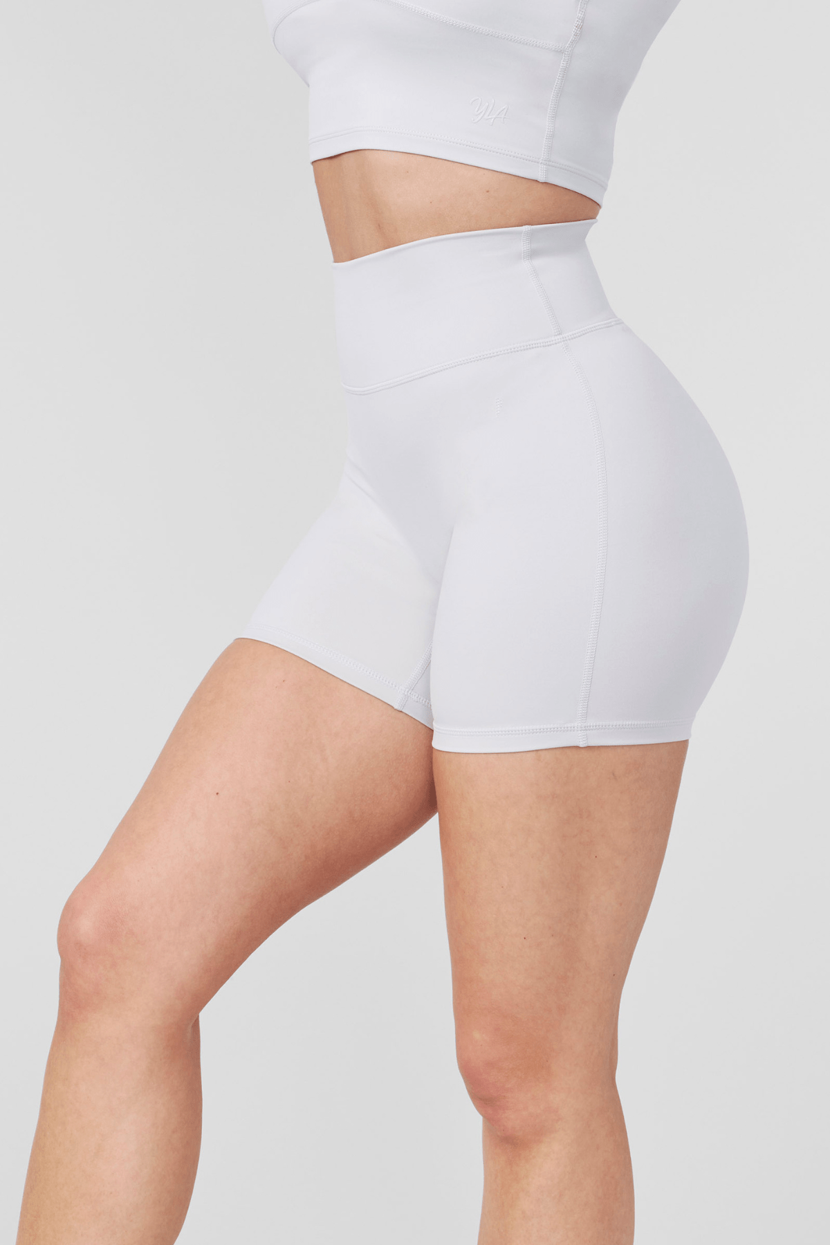 Mid-action photo of compression shorts men and women style in group hike setting near Austin trail.