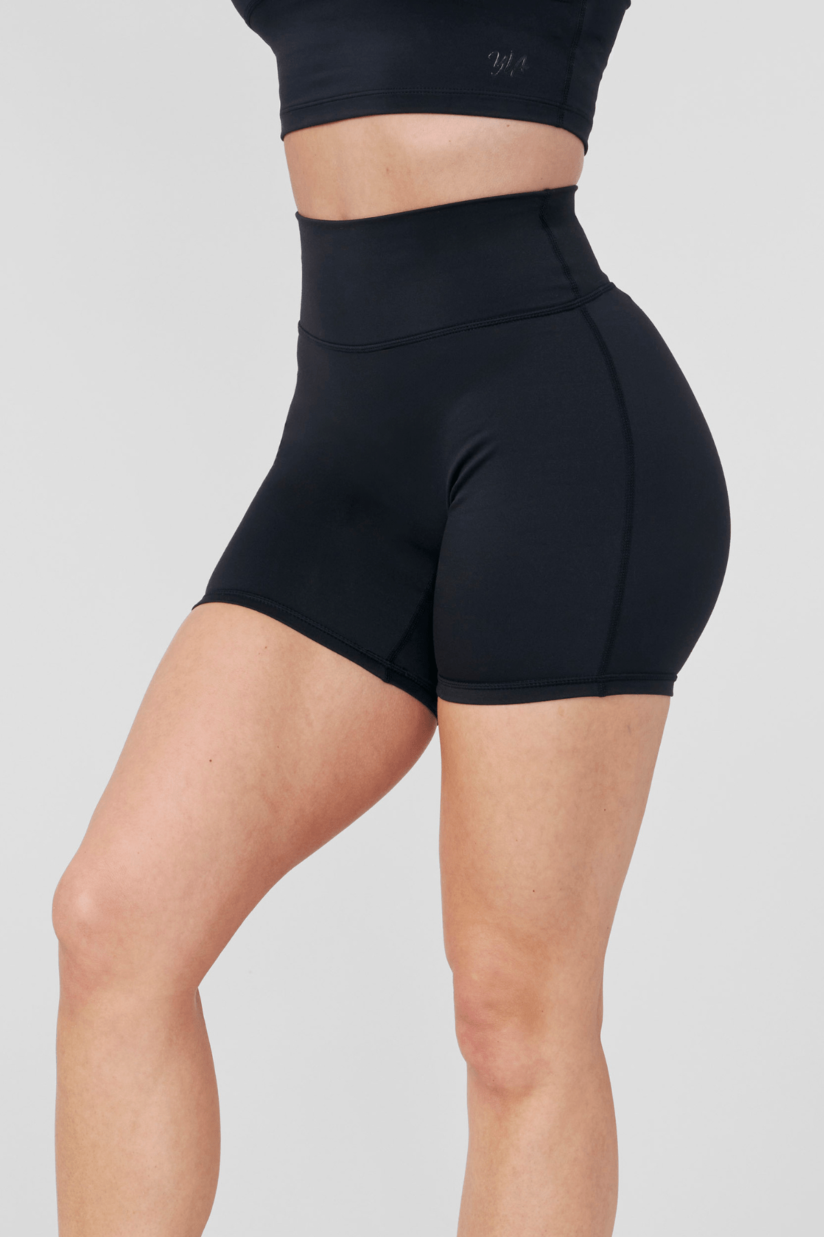 Back angle showing reflective logo and smooth waistline on biker shorts women style.