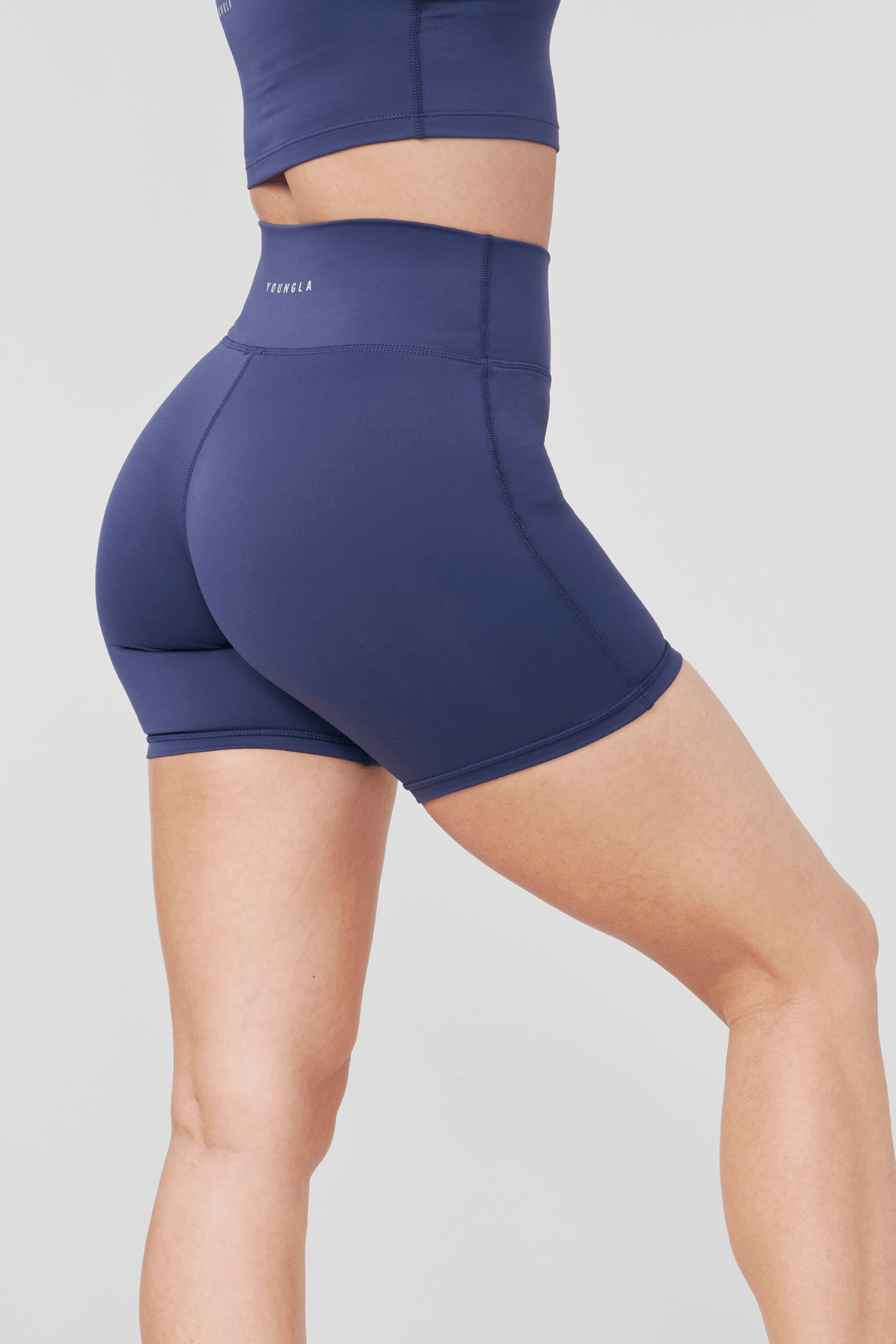 Front fit view highlighting no front seam on womens bike shorts in matte black.