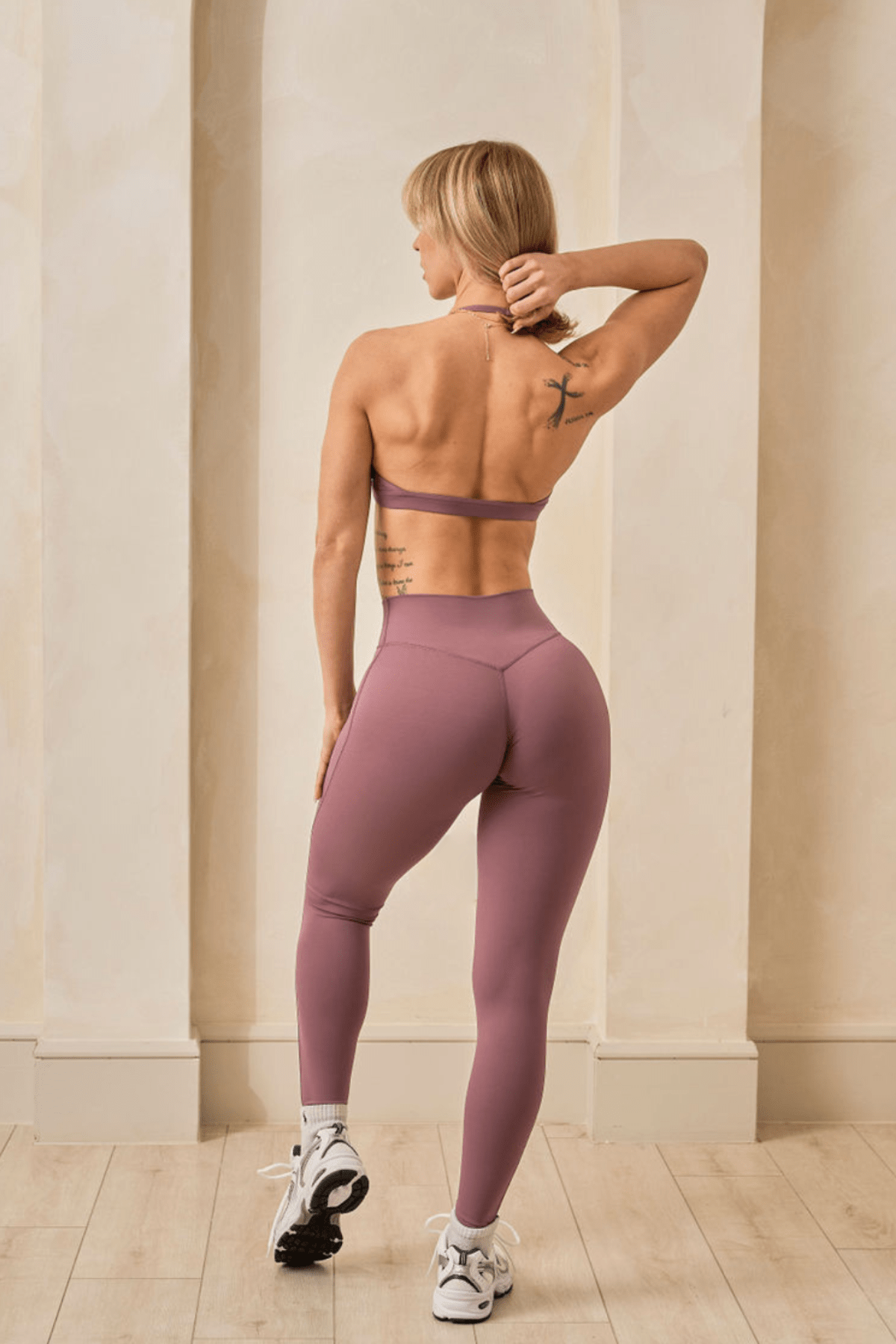 Full-body front view of high rise leggings styled with a cropped workout top