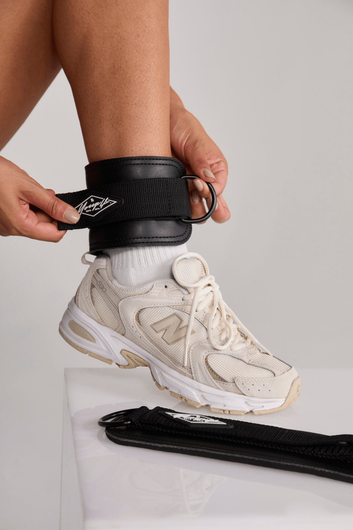 Side view of ankle strap ready for cable machine attachment