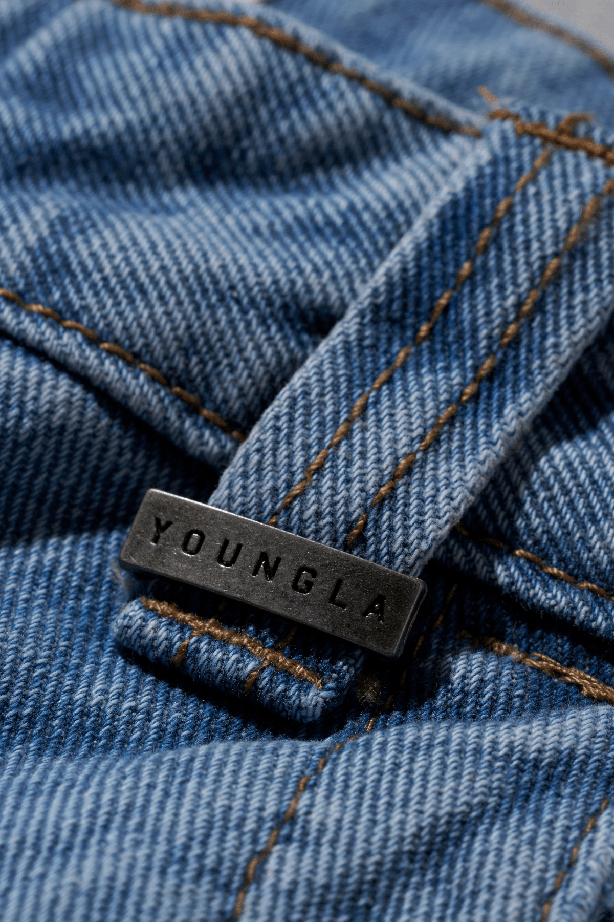 Side angle of the impact jeans showcasing the unique buckle design.