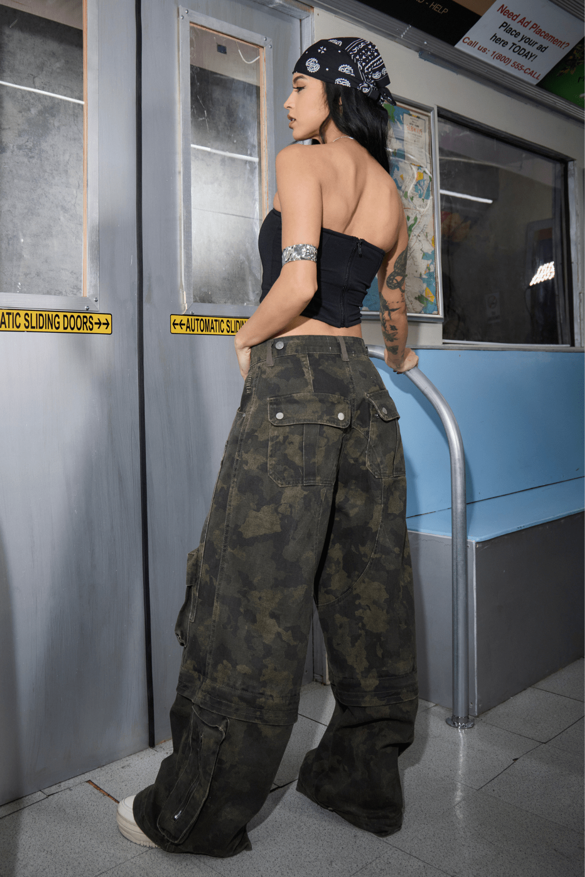 Wide leg carpenter jeans shown from side angle, paired with chunky sneakers