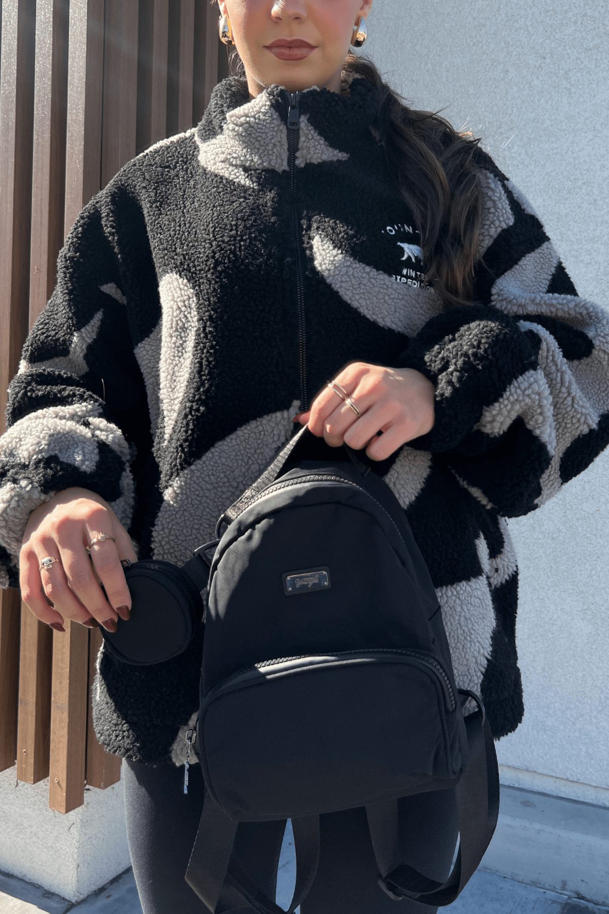 Lightweight backpack hanging on a park bench showing size and build
