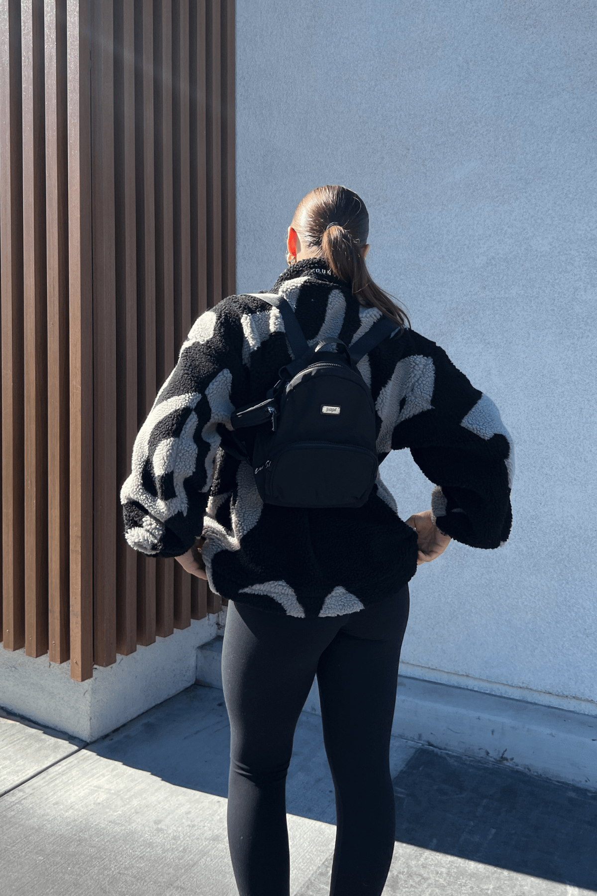 Front view of compact backpack worn by traveler in Memphis street