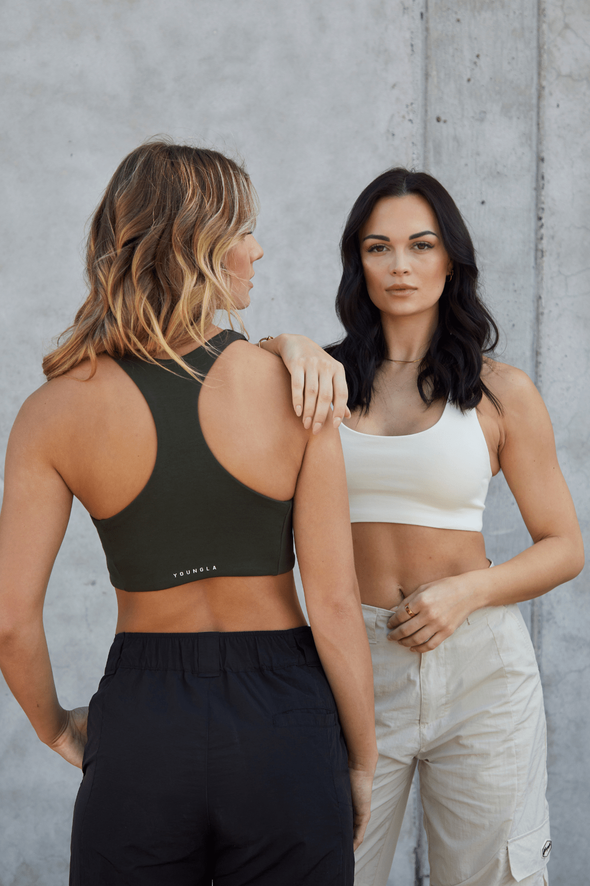 Model wearing the ladies racerback tank top during an outdoor workout session.