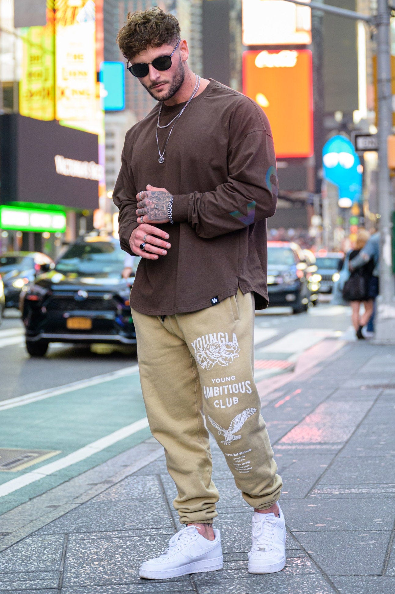 Joggers for women styled casually in urban outdoor setting with sneakers