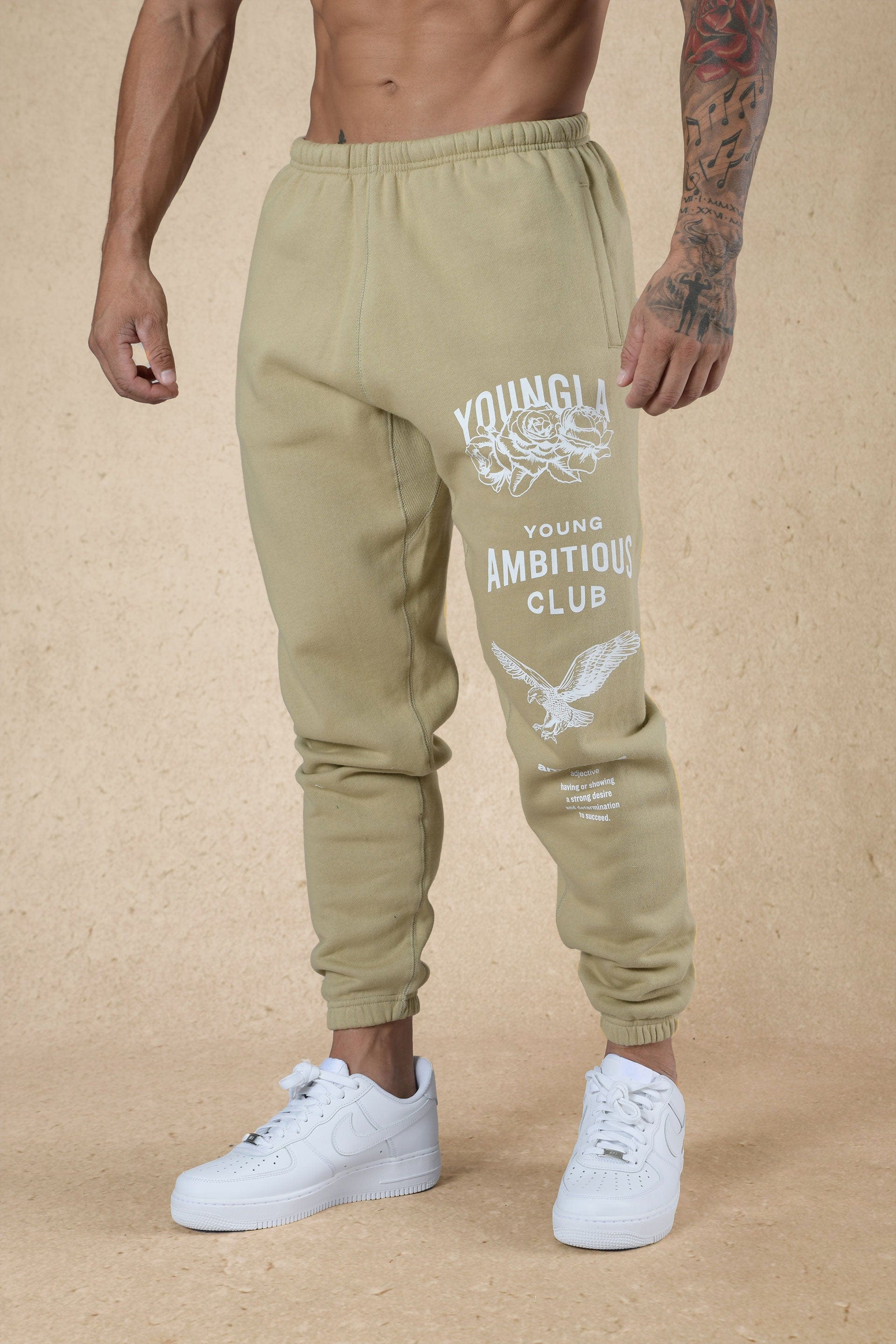 Joggers for women styled casually in urban outdoor setting with sneakers