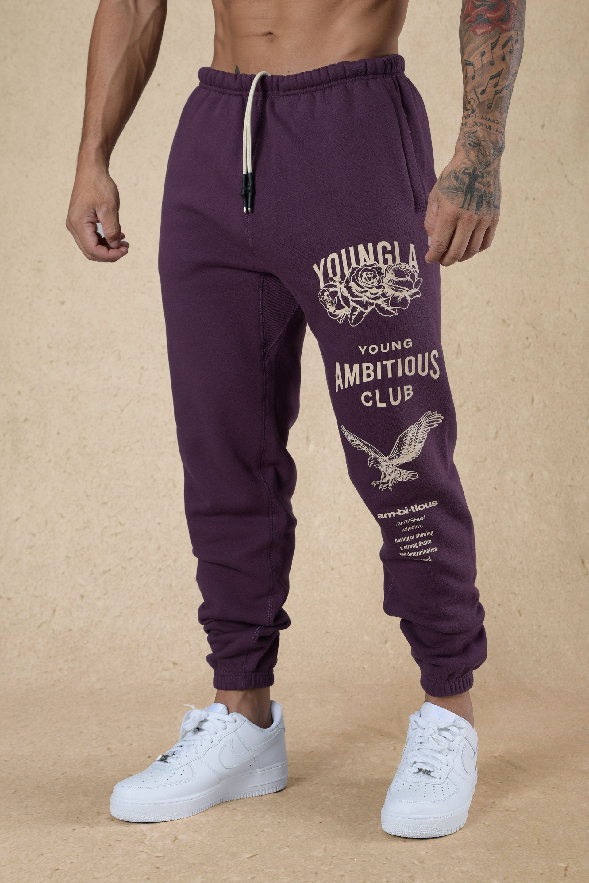 Front angle view of mens joggers showcasing oversized fit and printed leg design
