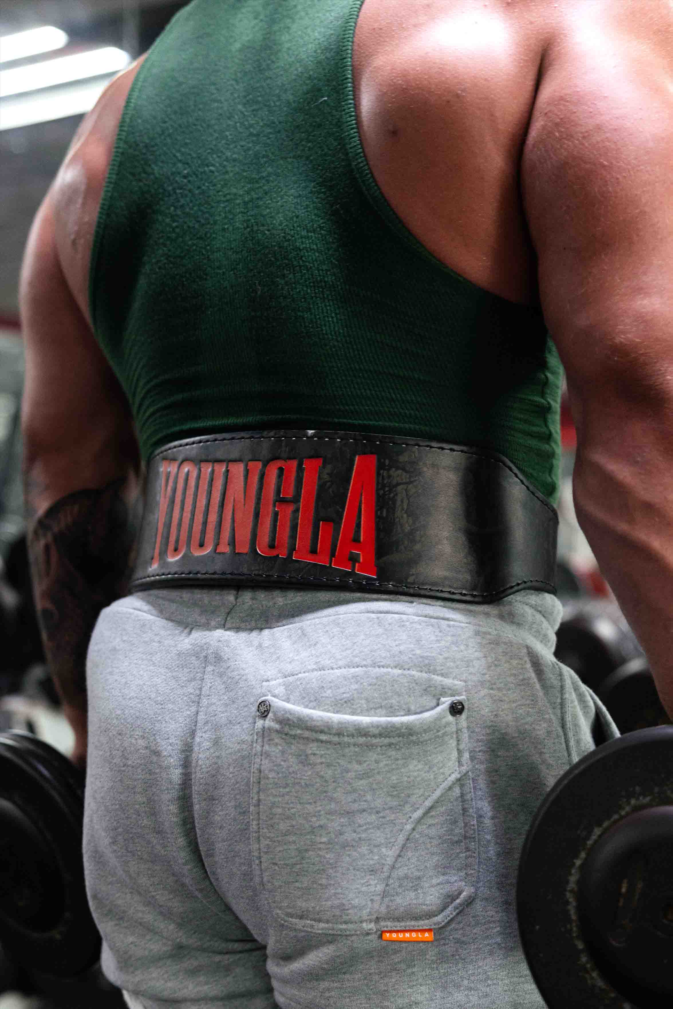 Tree camo leather lifting belt worn during a powerlifting session for maximum support.