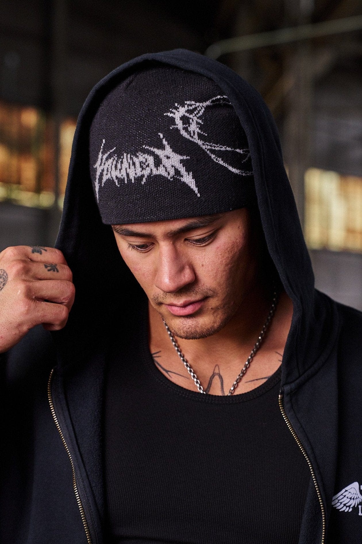 Model wearing the barbed wire beanie with a streetwear outfit in an urban environment