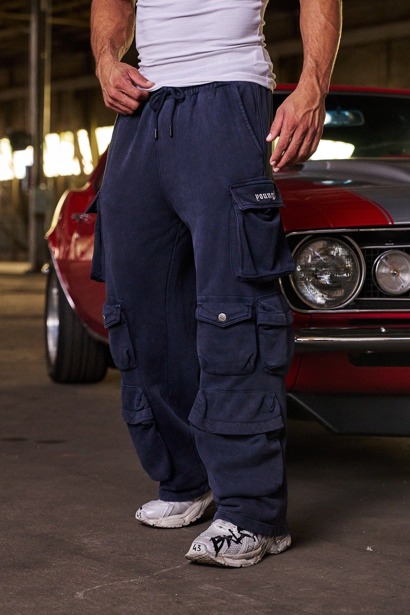 Cargo pocket close-up on mens joggers featuring YLA branding