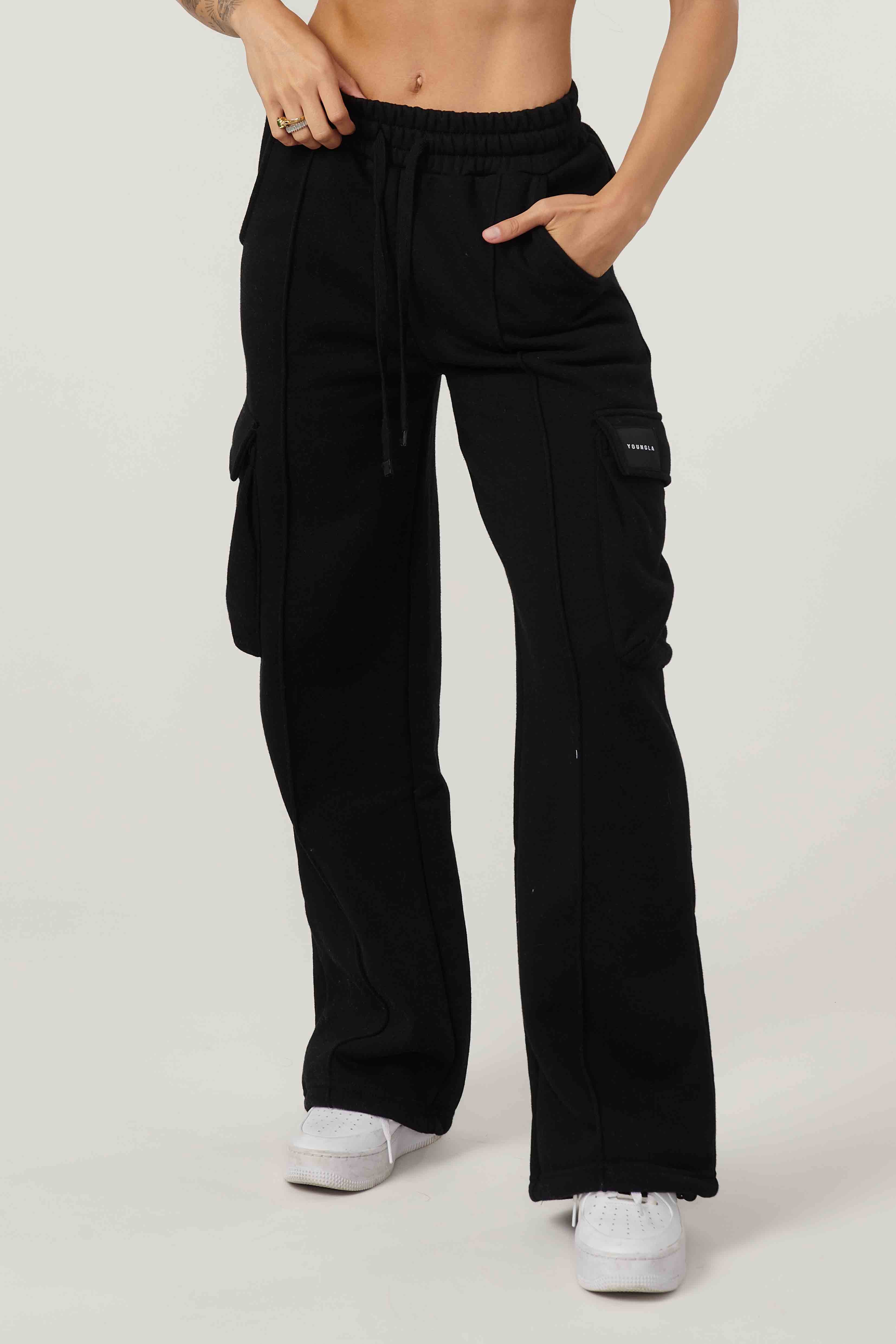 Model wearing fleece cargo pants in outdoor setting, showcasing relaxed fit