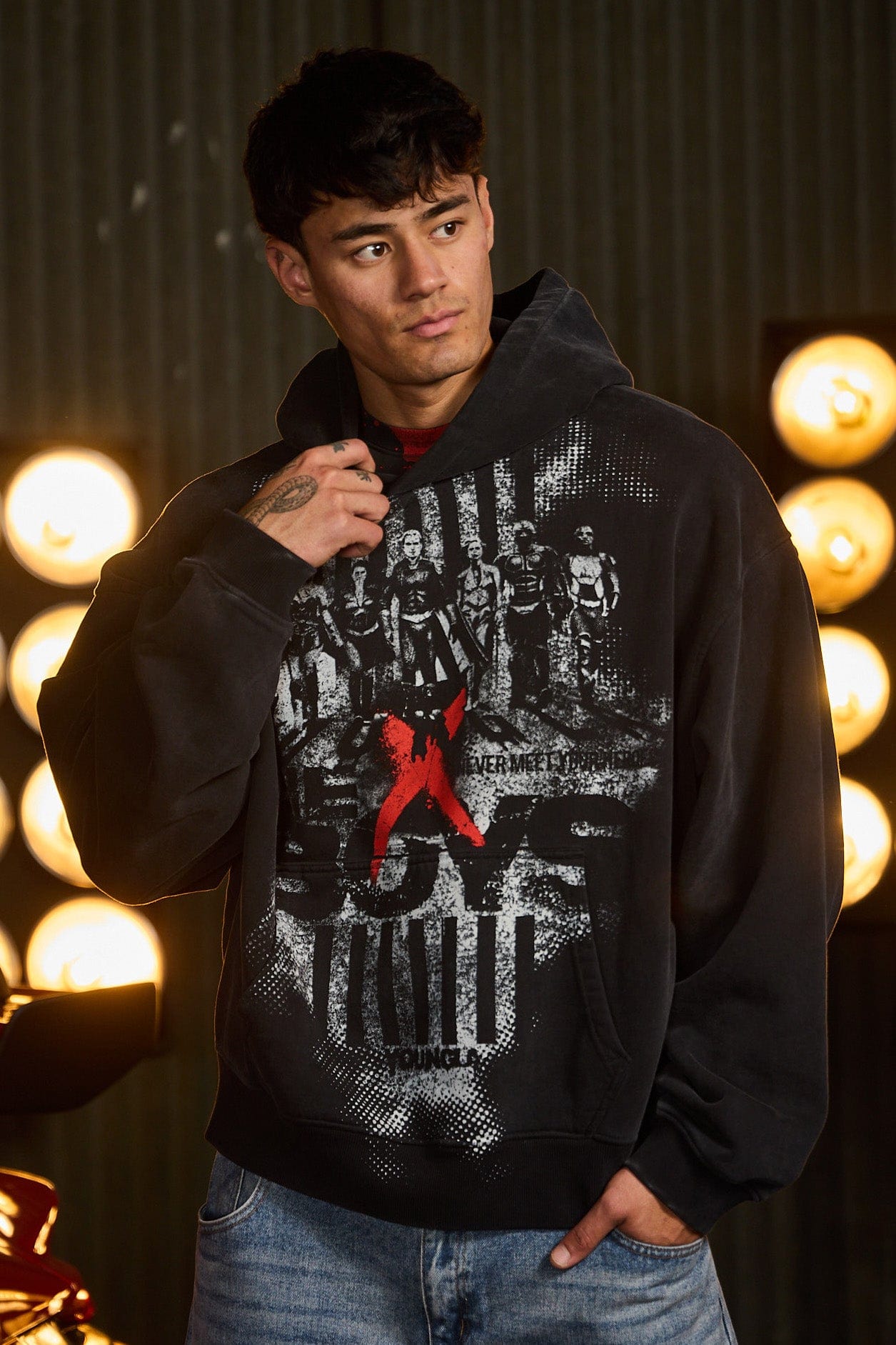 Back view of the mens graphic hoodie in a casual street setting.