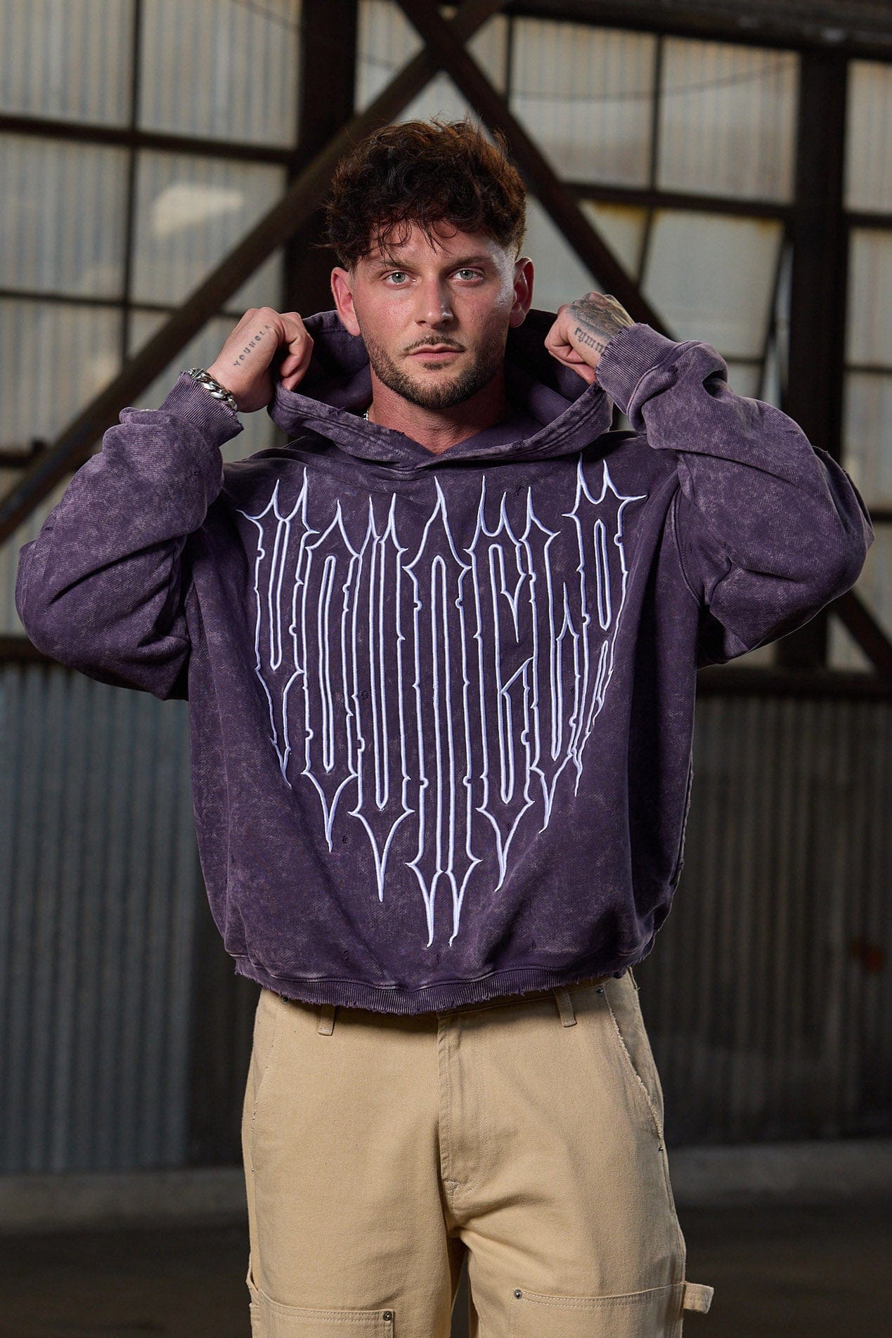 Close-up of embroidered Revenge logo on the oversized zip up hoodie