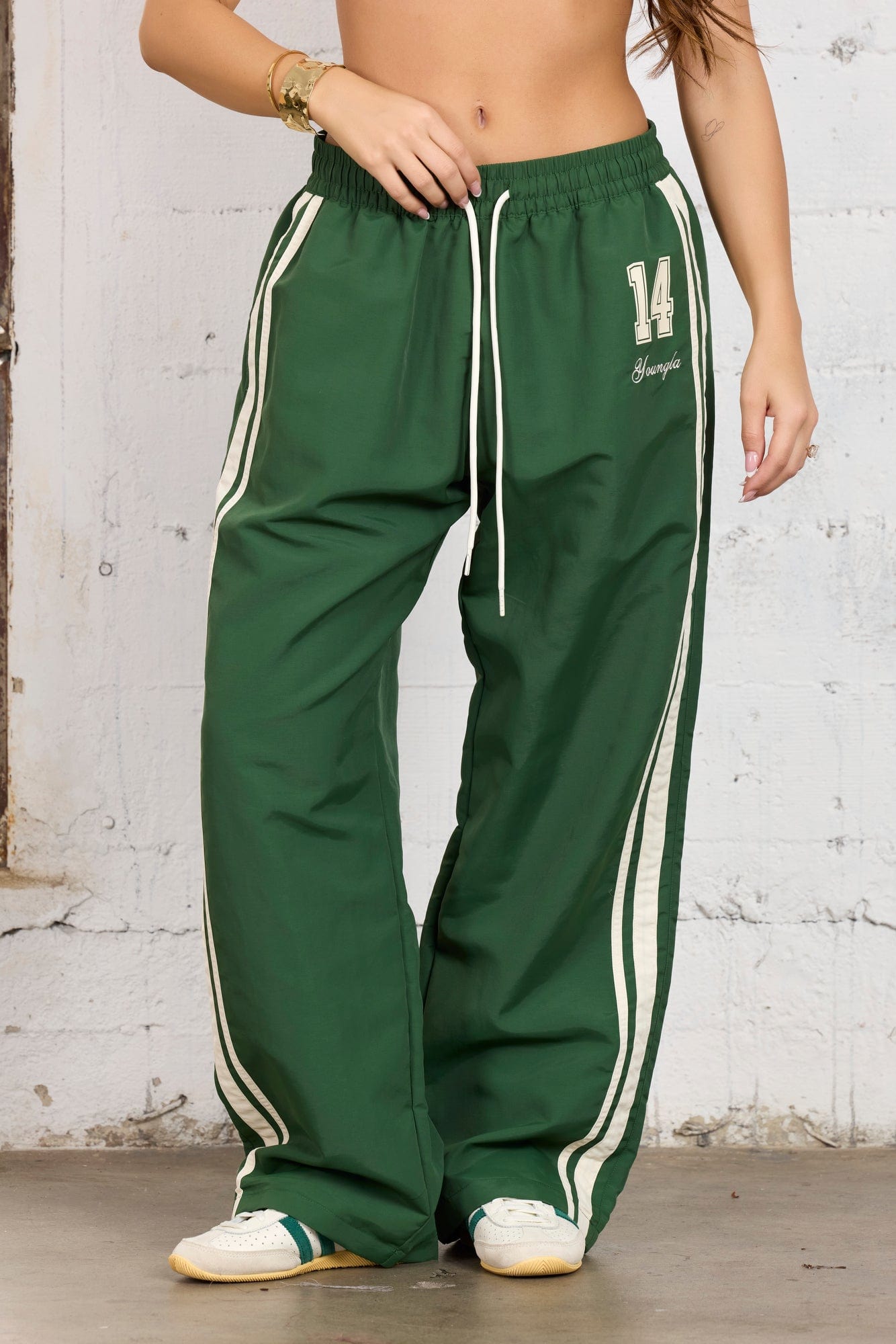 Model wearing oversized track pants, ideal for workouts.
