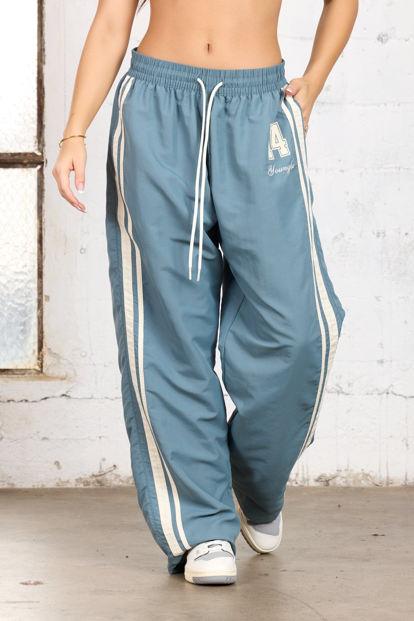 Model wearing oversized track pants, ideal for workouts.