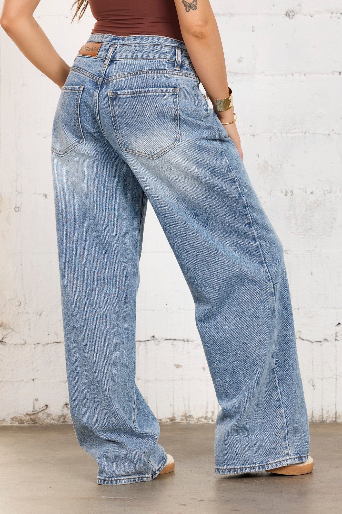 Front view of mid rise straight leg jeans on a model