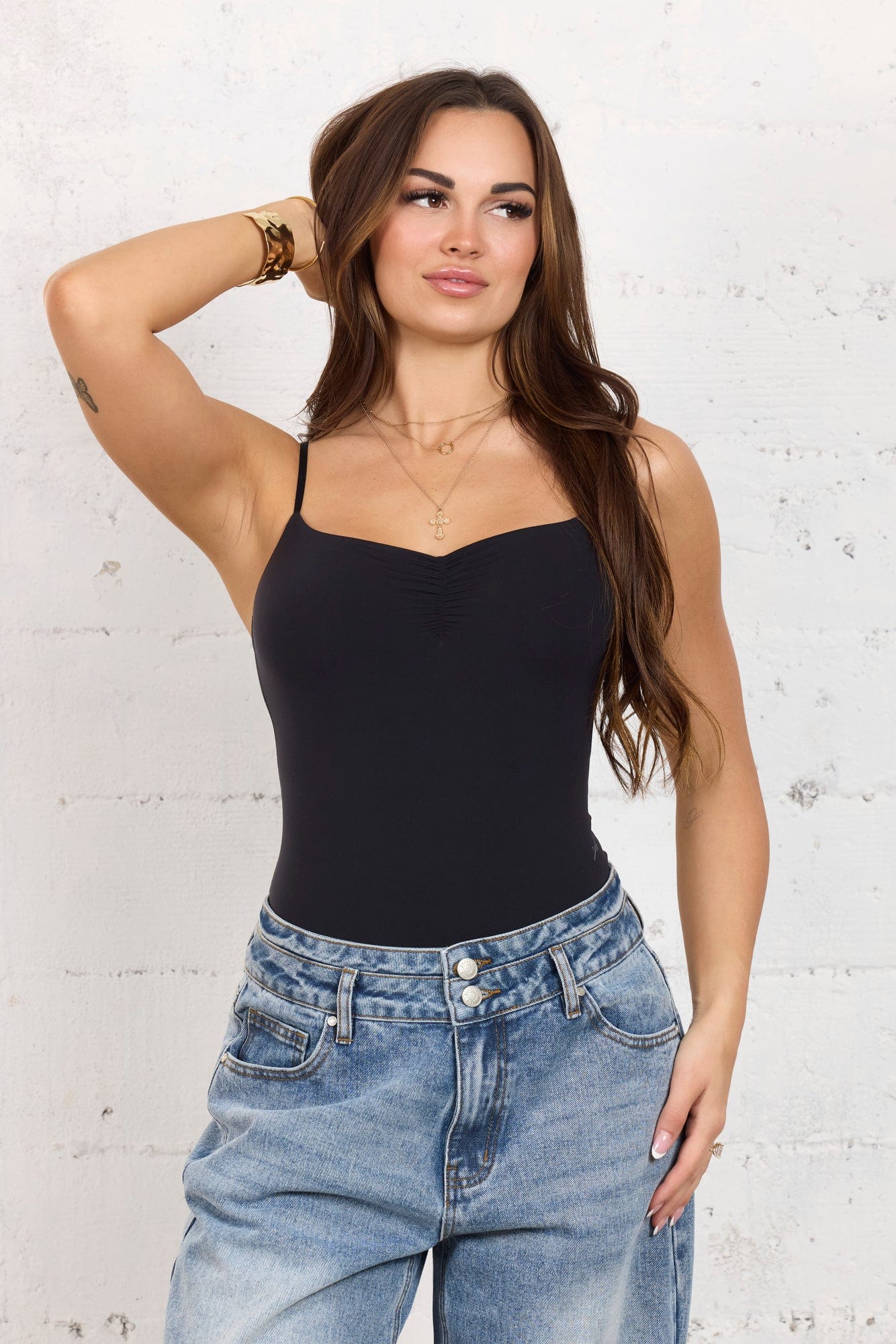 Model wearing the bodysuit under a stylish dress.
