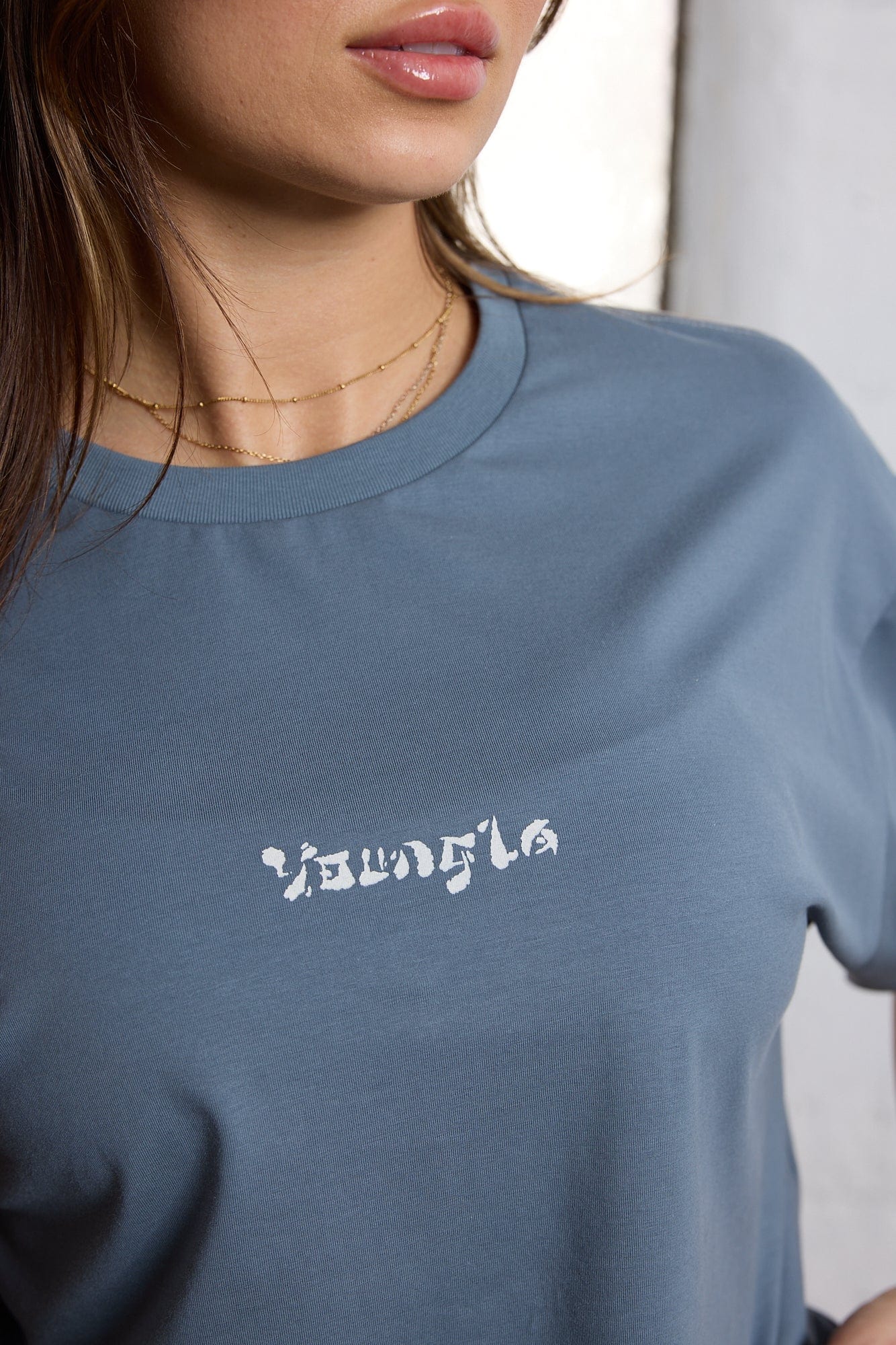 Model wearing the oversized t shirt, styled with casual shorts.