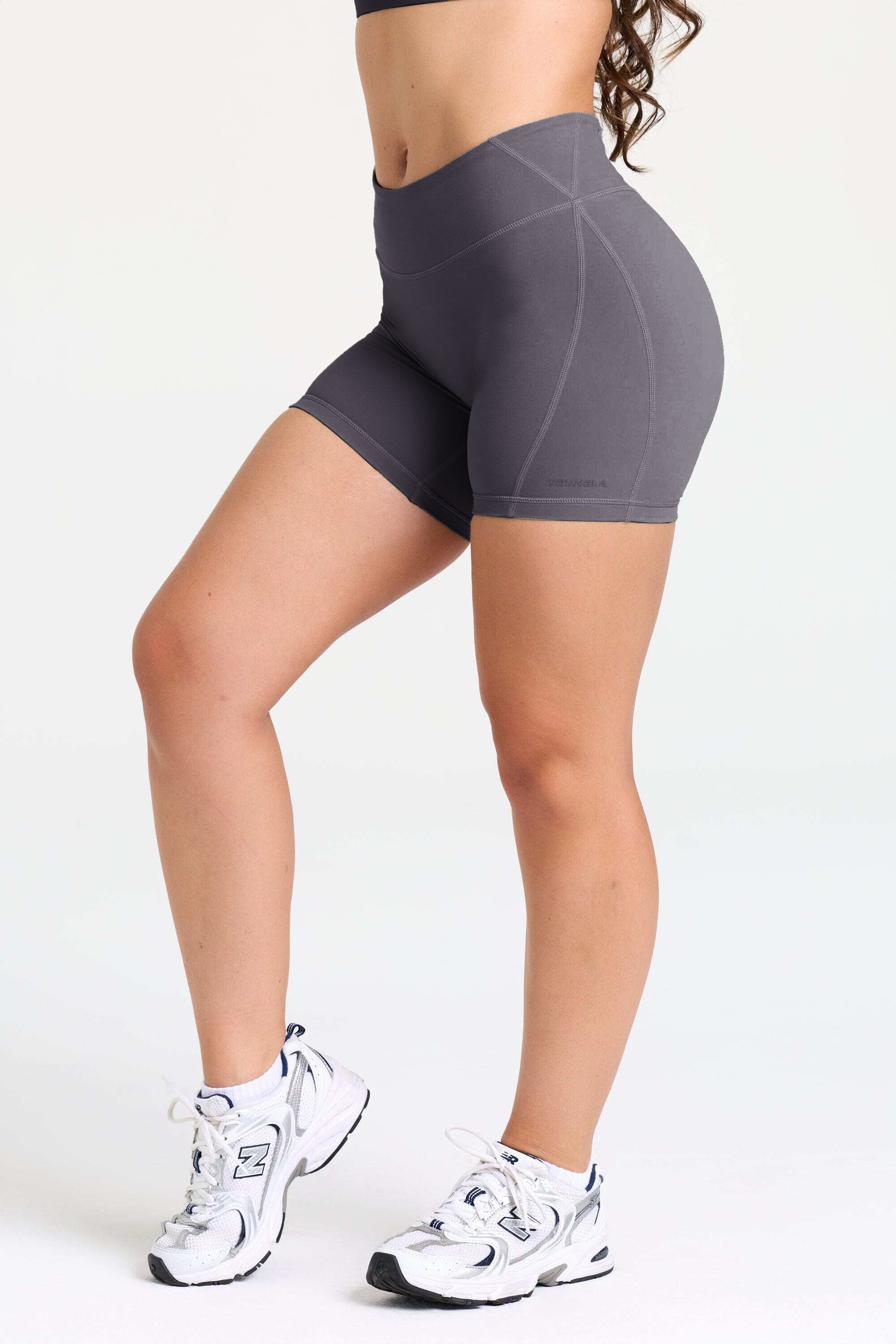 Model wearing the W160 Legacy Flow Shorts during yoga practice outdoors