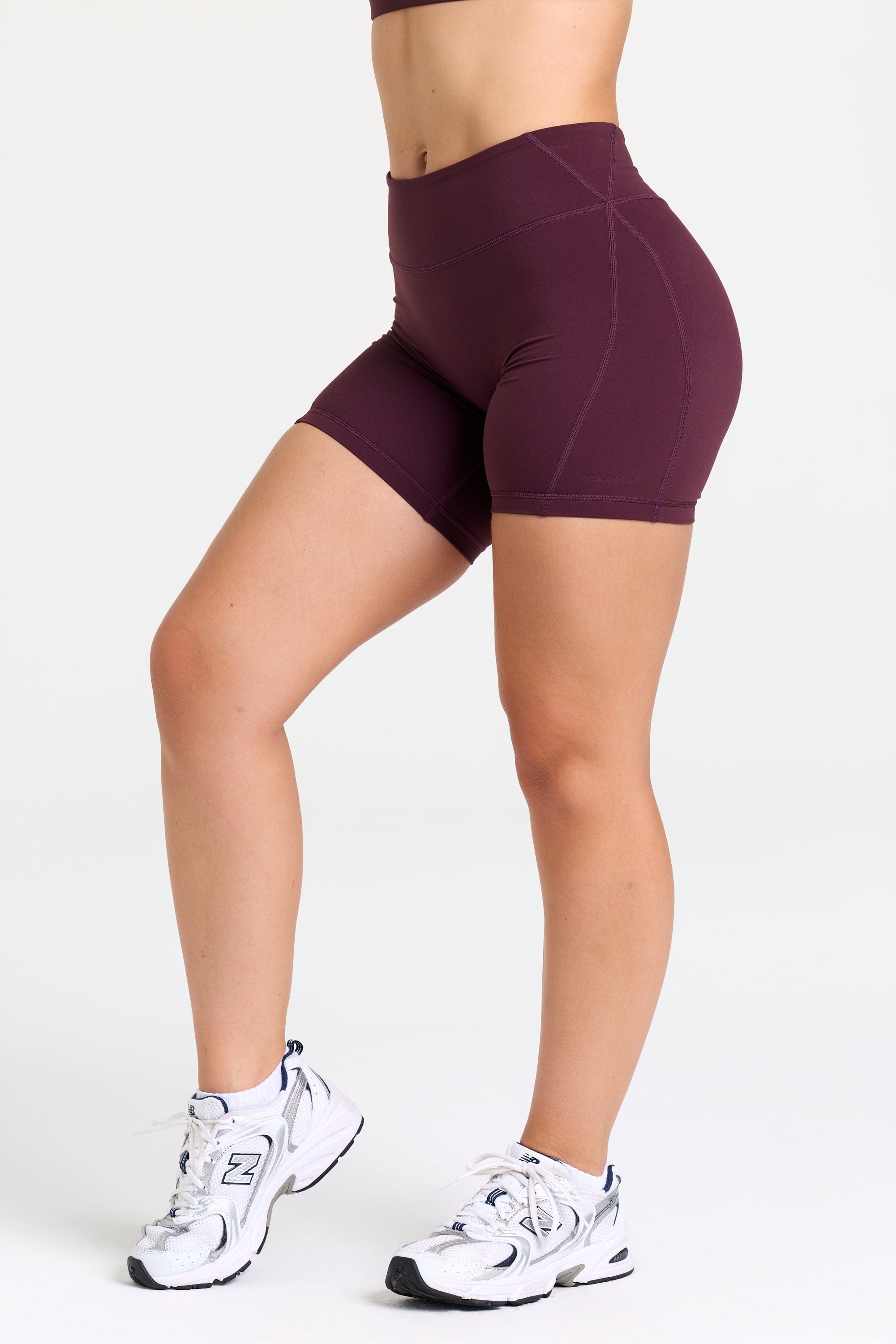 Model wearing the W160 Legacy Flow Shorts during yoga practice outdoors