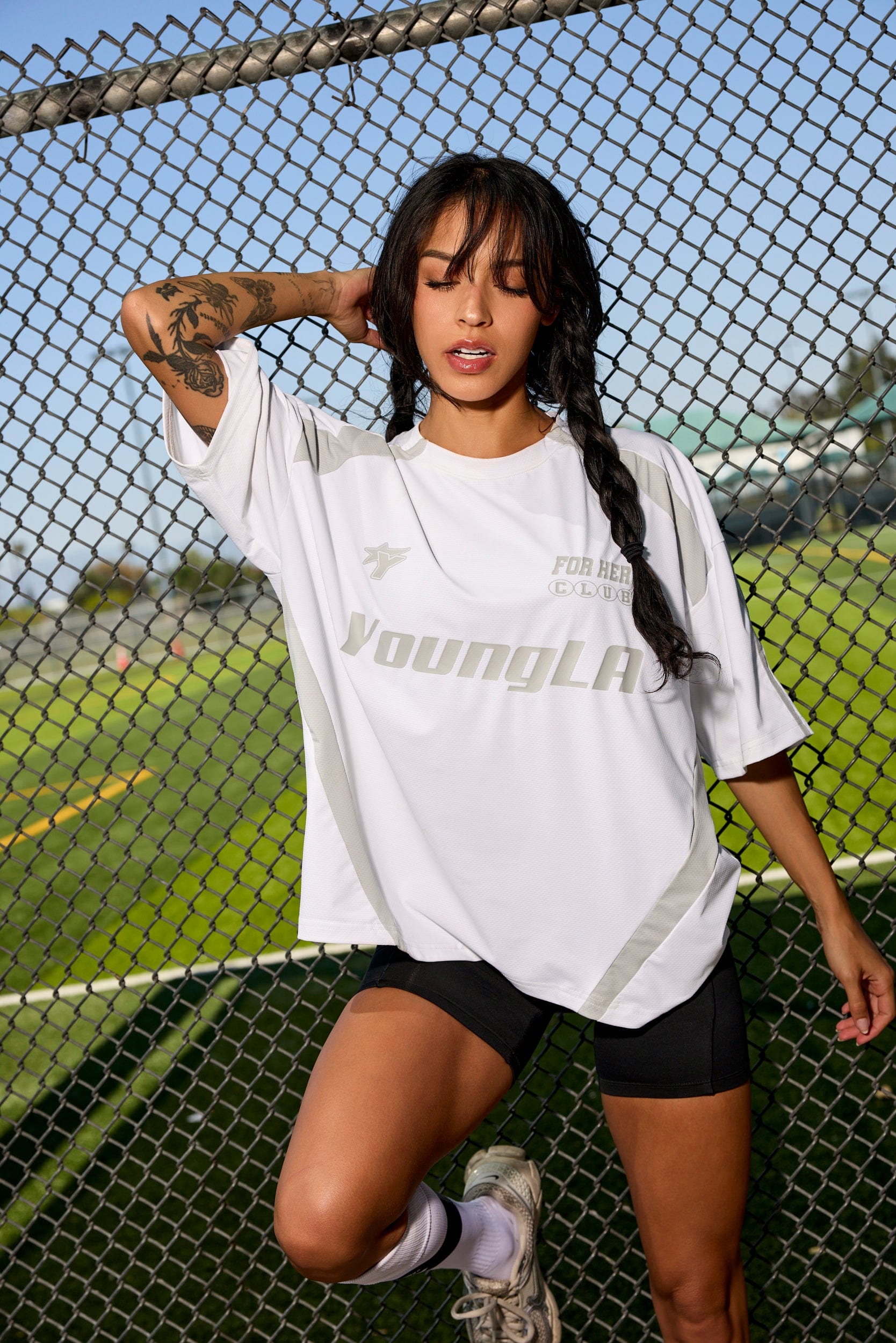 Model wearing oversized jersey outdoors near Georgia stadium