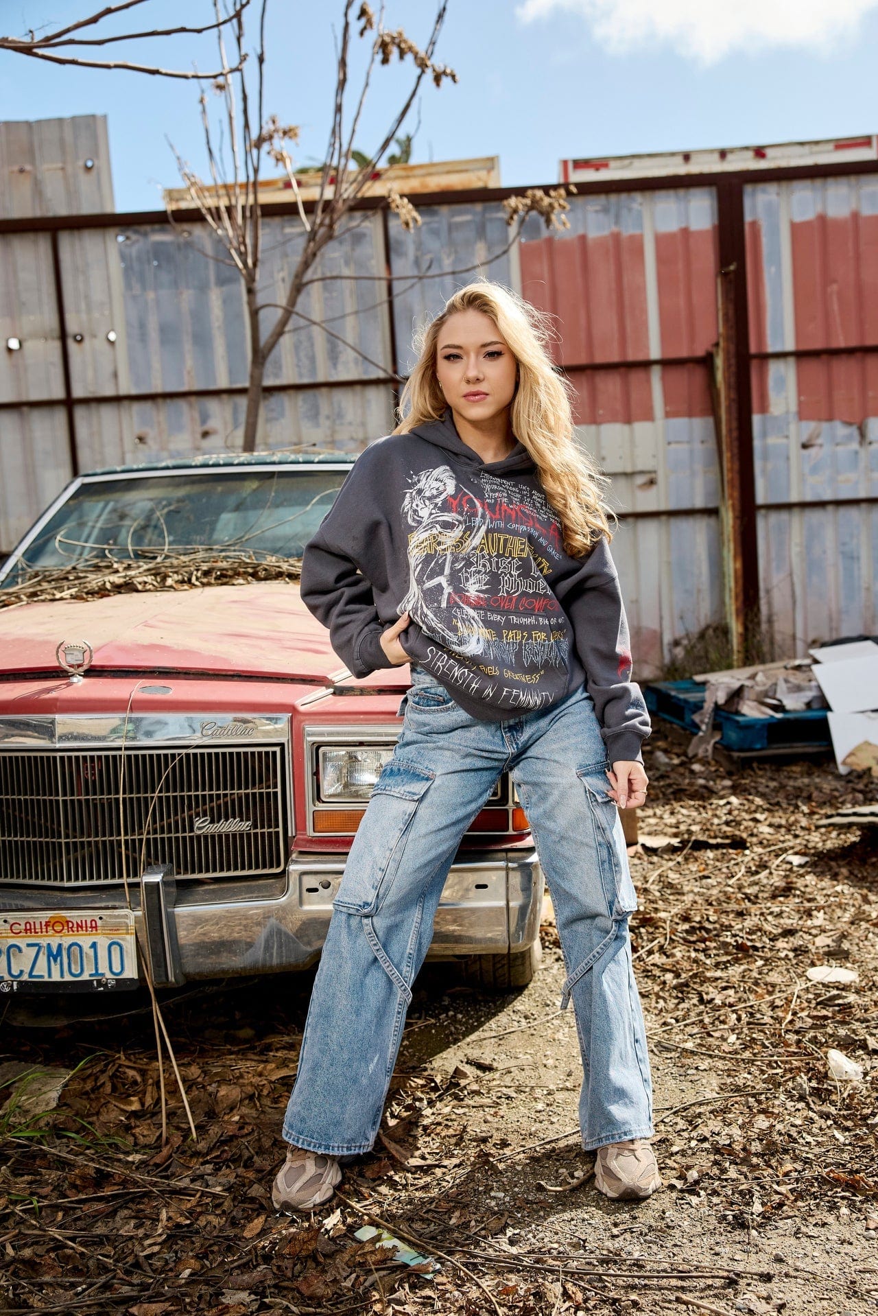 Front view of dominate jeans styled with boots, showing full straight-leg silhouette.