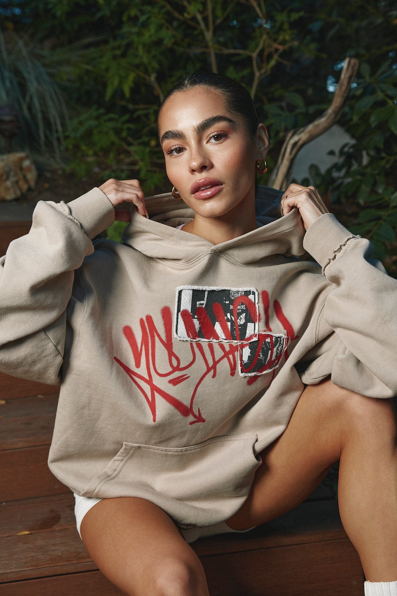 Side profile showing oversized fit of zip-up hoodie