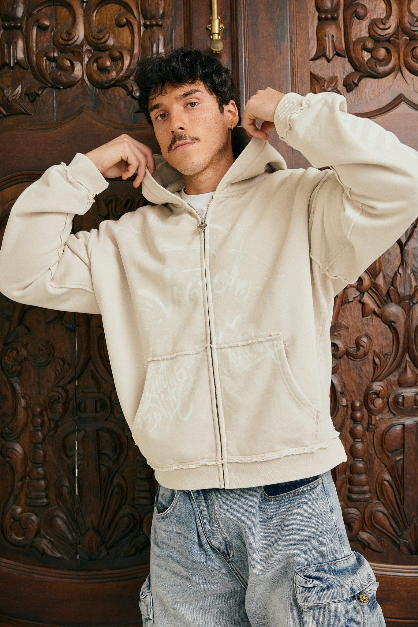 Model wearing oversized hoodie front view with cargo pants on NYC street