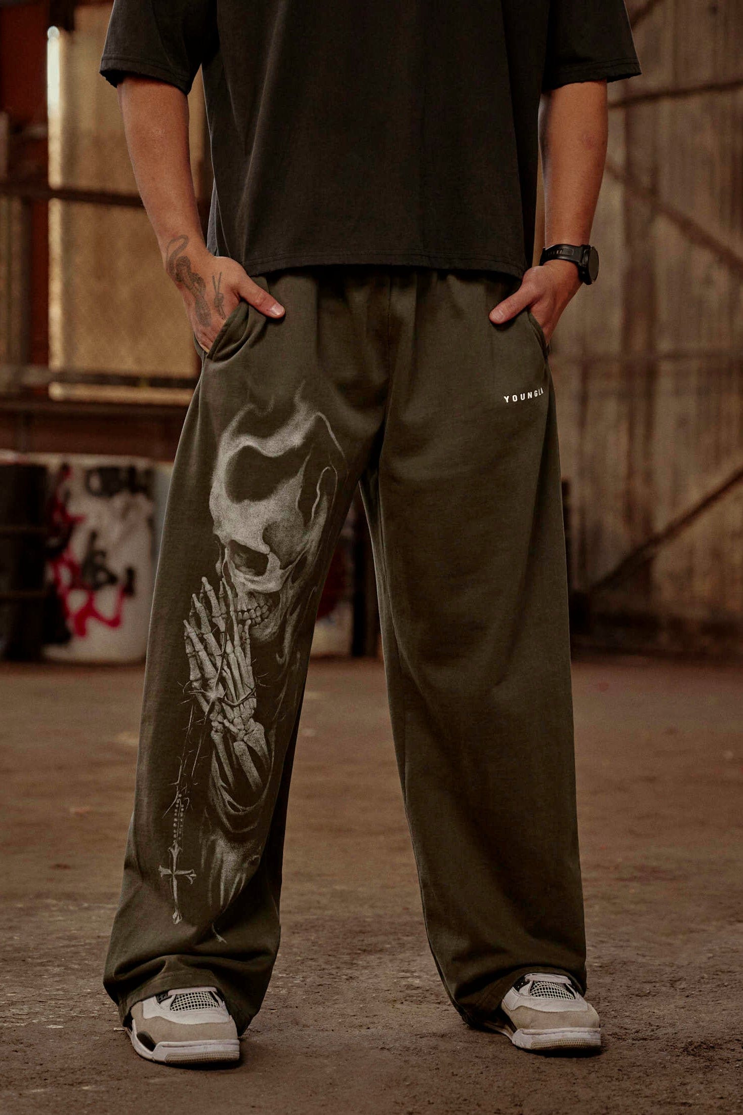 Model wearing baggy Divine Sweats in urban setting