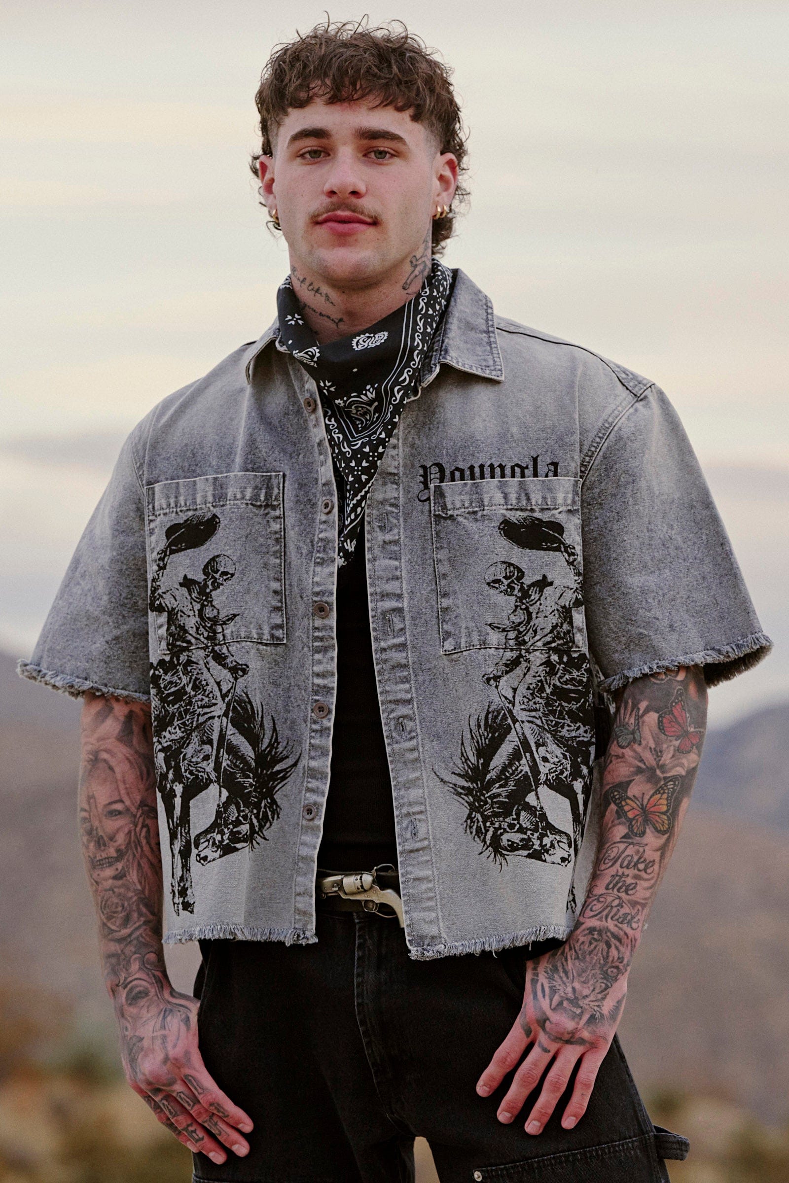 Close-up of distressed sleeve detailing on men's short sleeve button up