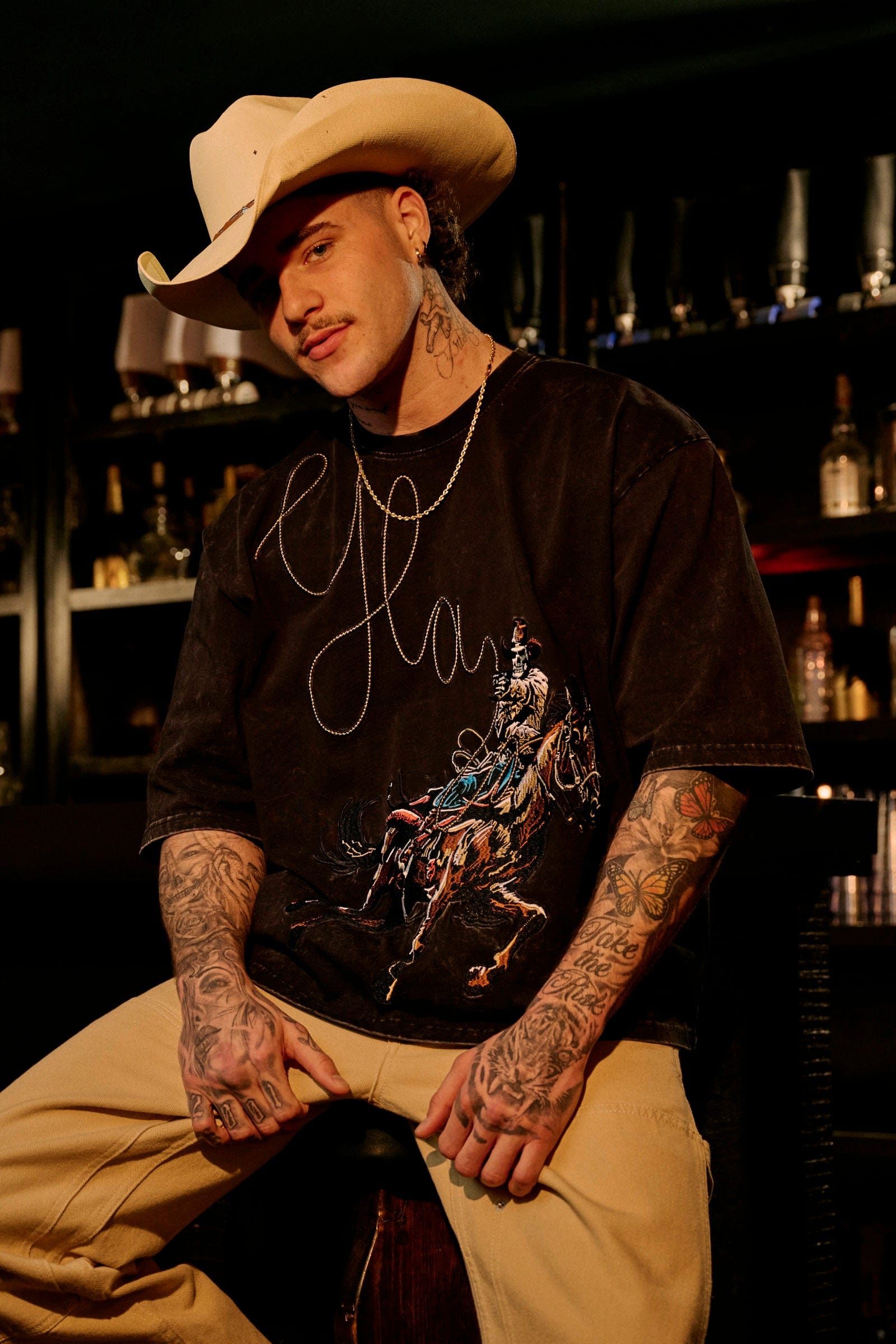 Close-up of the cowboy embroidery detail on the t shirt.