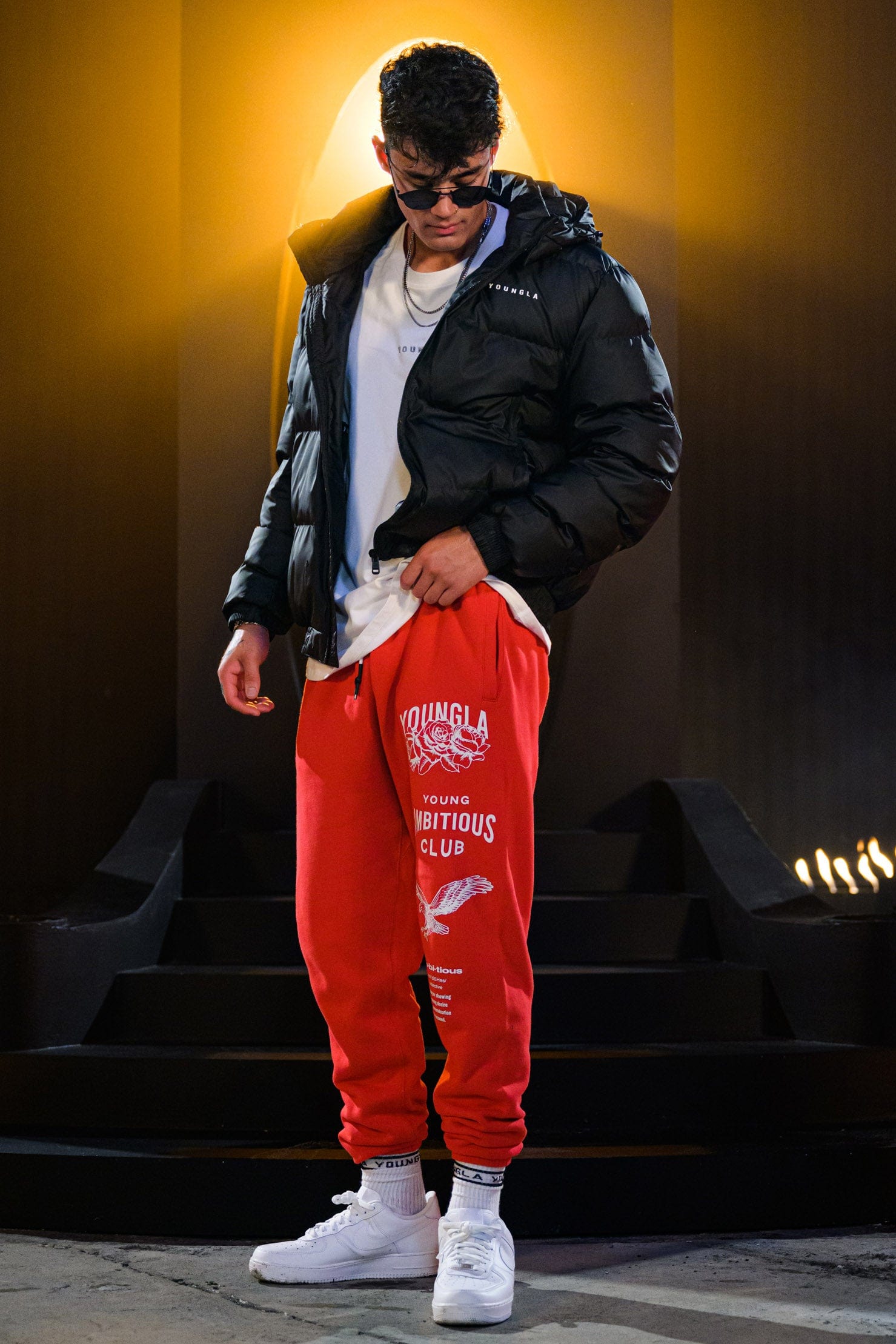 Joggers for women styled casually in urban outdoor setting with sneakers