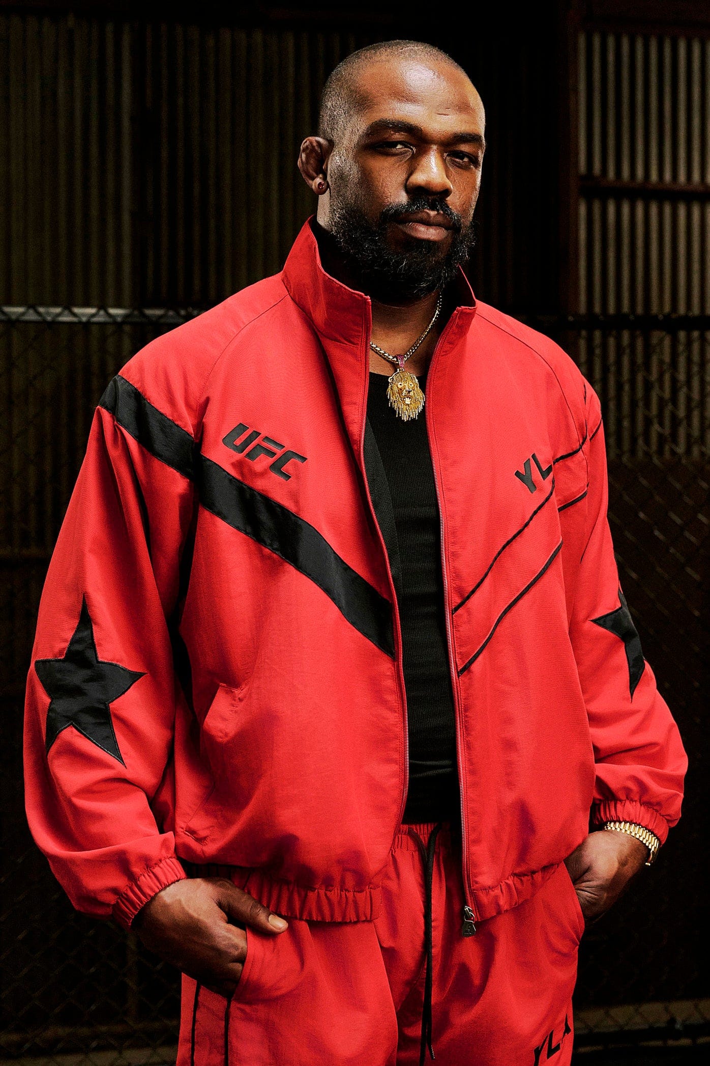 Side view of the mens gray sports jacket, highlighting the star patch and piping details.