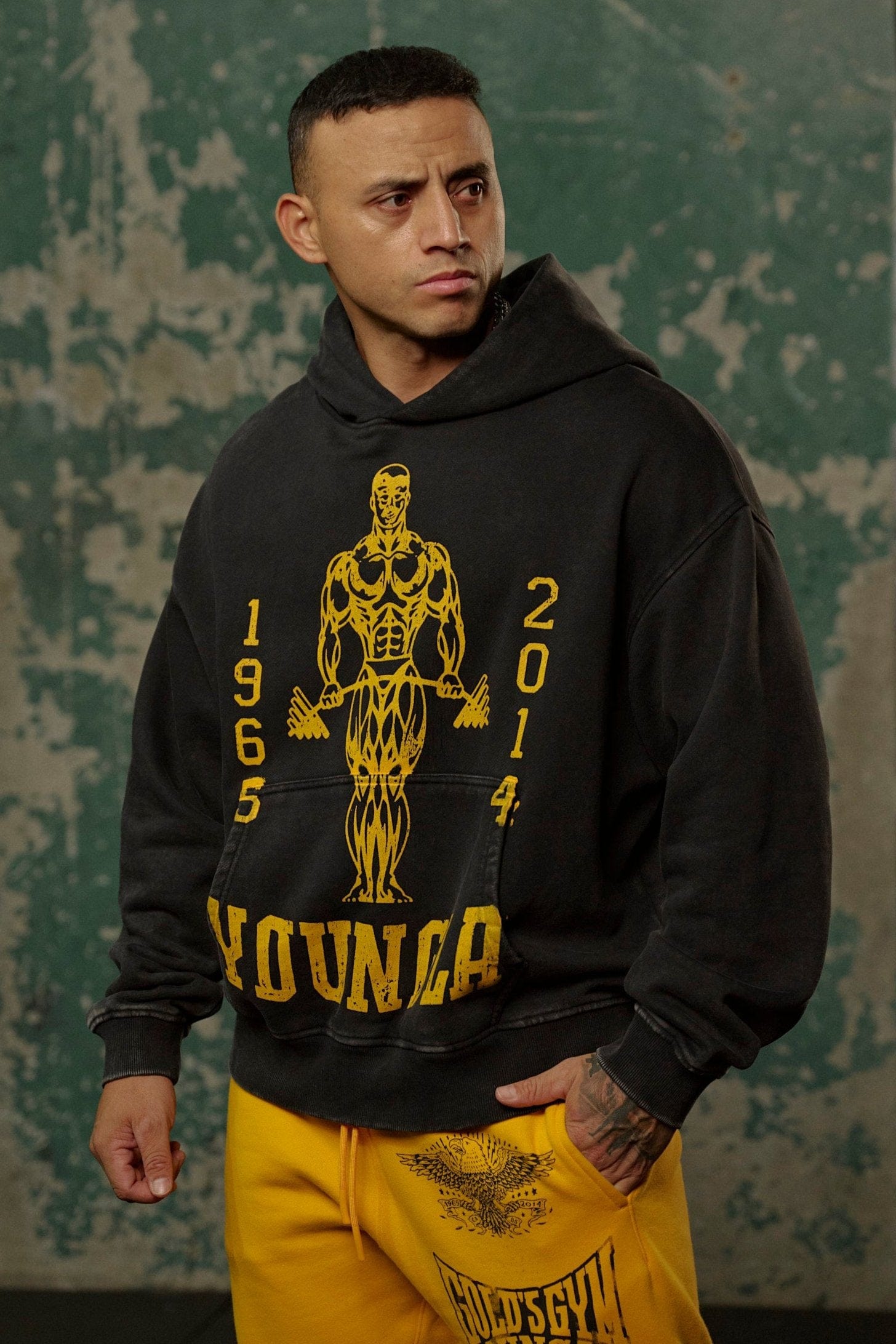 Back angle of oversized zip up hoodie worn at the gym