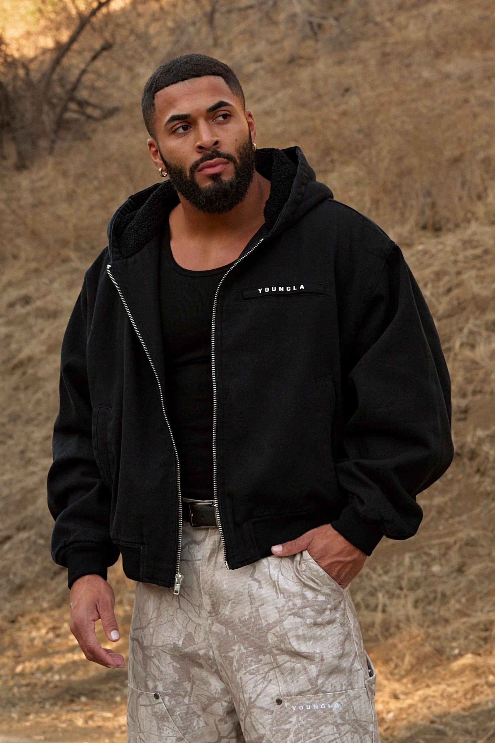 Model wearing oversized jean jacket with sherpa lining in urban setting