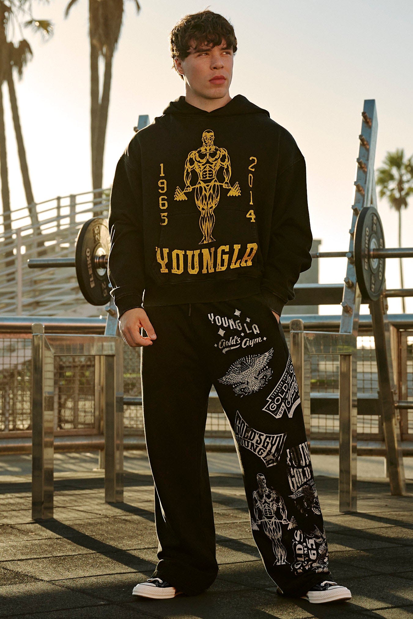 Back angle of oversized zip up hoodie worn at the gym