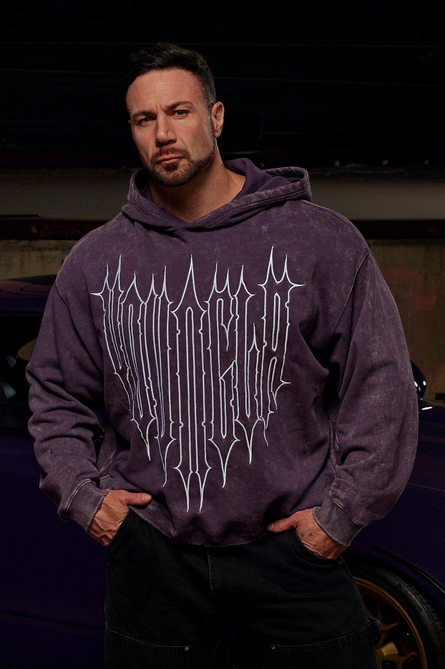 Close-up of embroidered Revenge logo on the oversized zip up hoodie