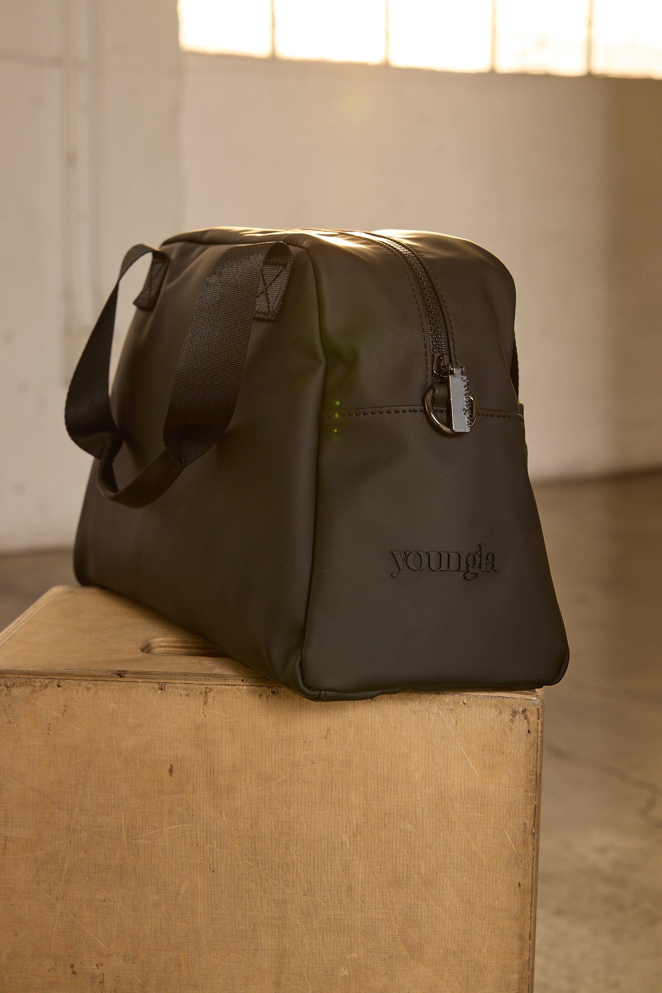 Front view of the sleek mini duffle bag showcasing its pockets.