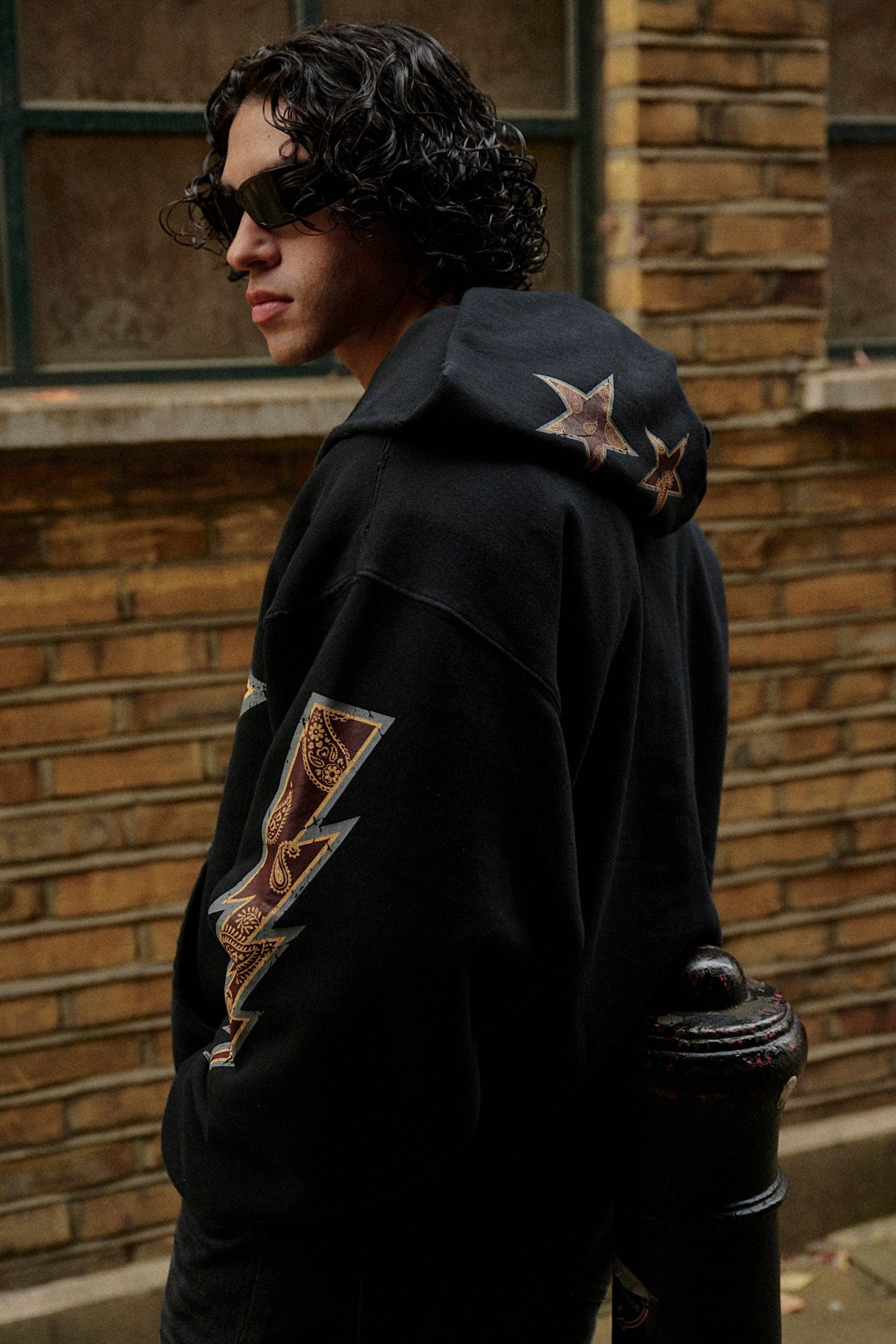 Front view of the Superstar Comfort Hoodie with star graphic and thunderbolt prints.