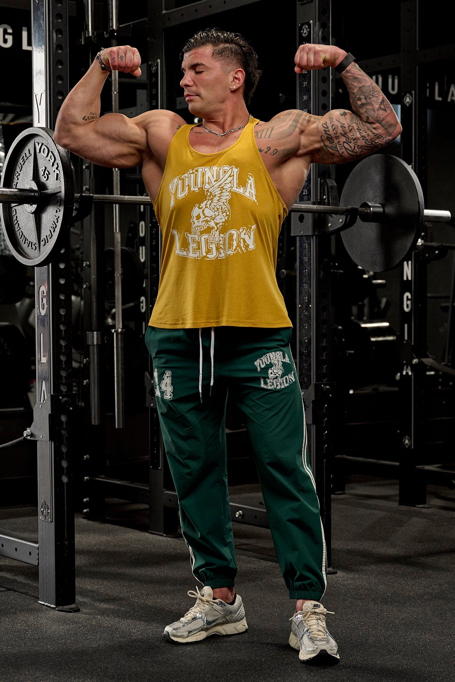 Model wearing Legion performance gym stringer in a workout setting.