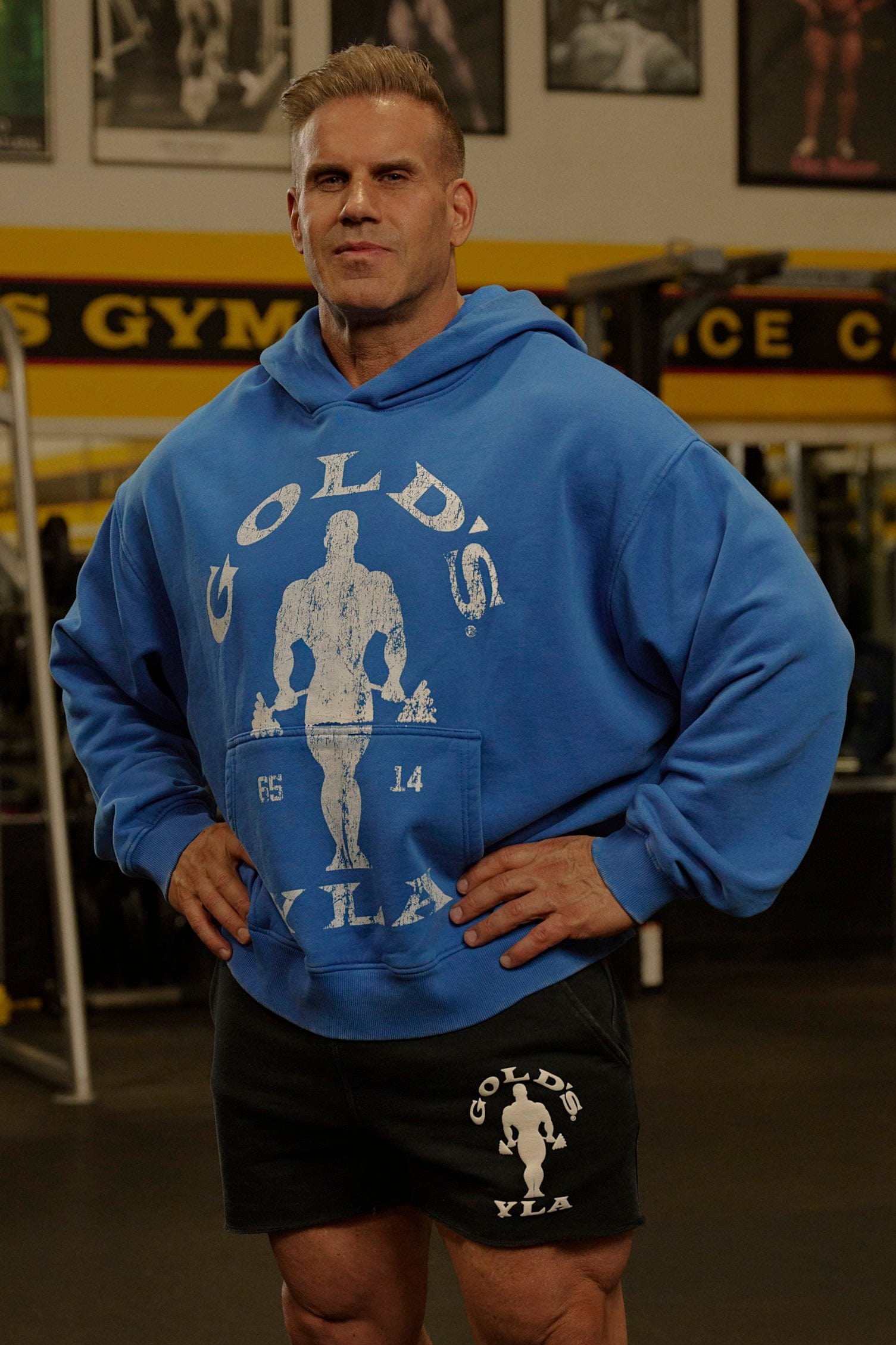 Side profile of model wearing terry fleece hoodie outdoors