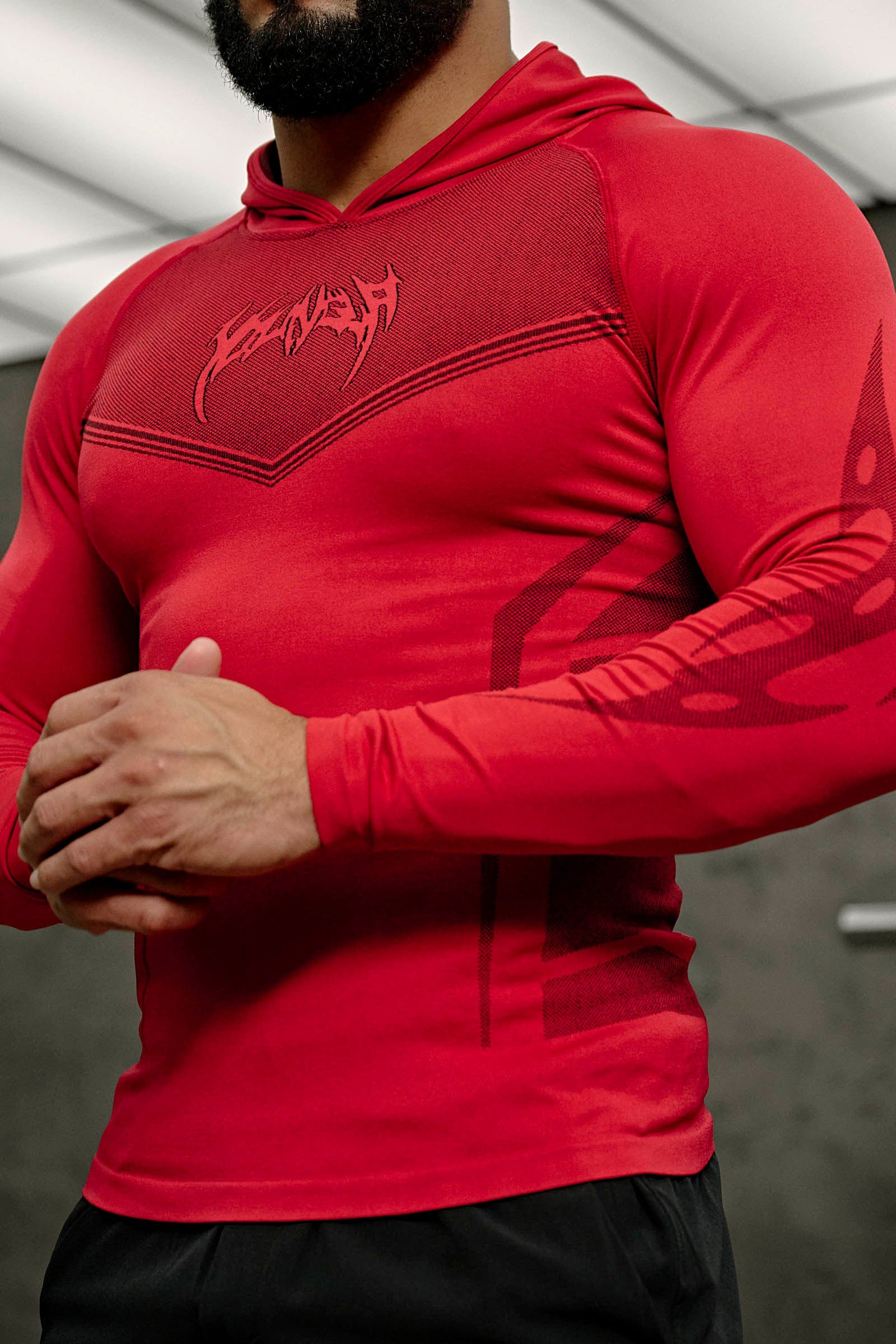Side view of the mens performance hoodie highlighting the tribal jacquard design.