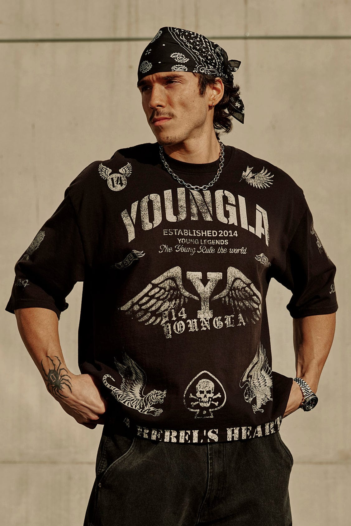 Model wearing the Rebel Vintage Graphic Tee in a casual outdoor setting.