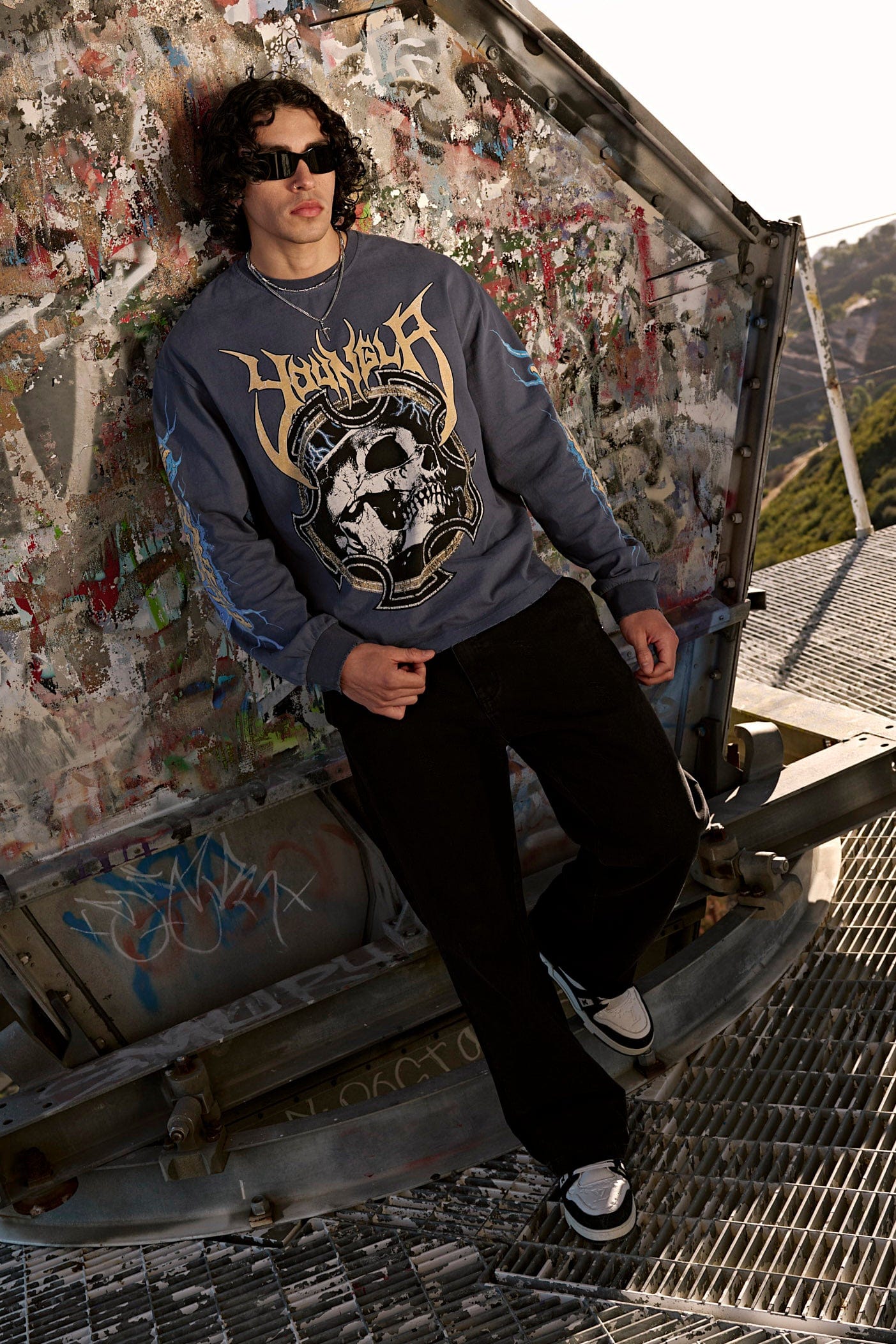Side profile of model in relaxed fit long sleeve t-shirts