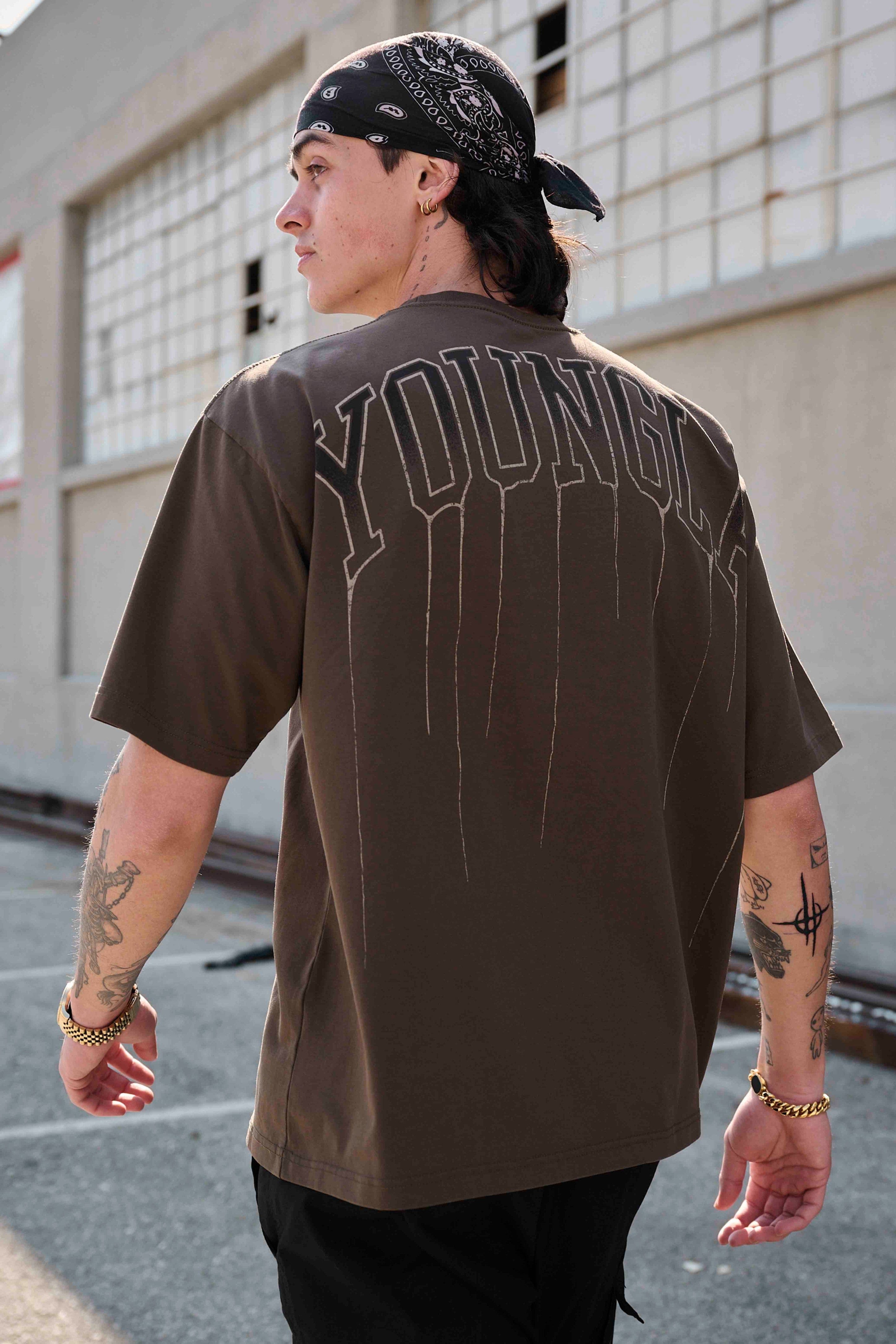 Front view of unisex oversized cropped tee on hanger, showing drape